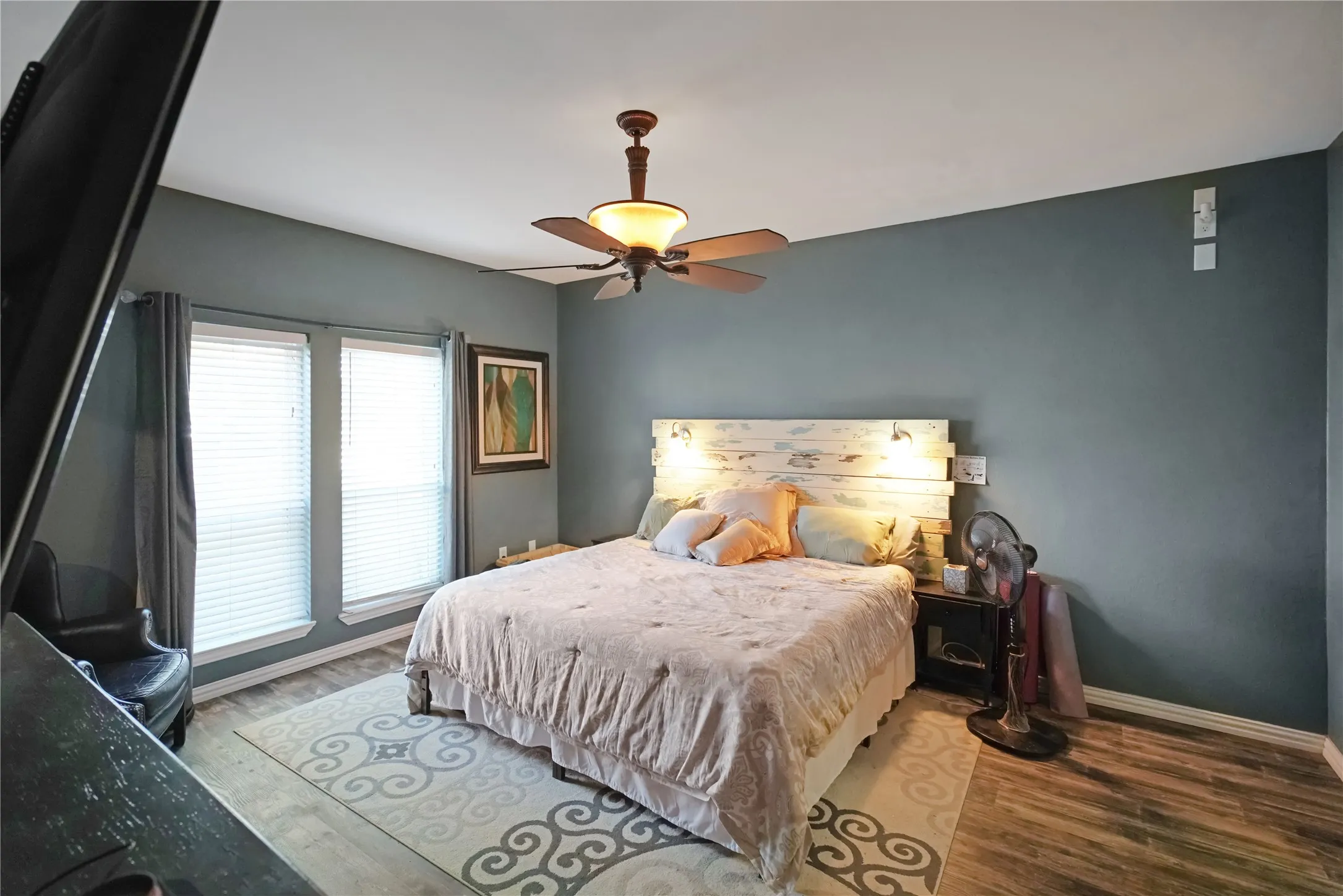 Bedroom with wood finished floors and ceiling fan