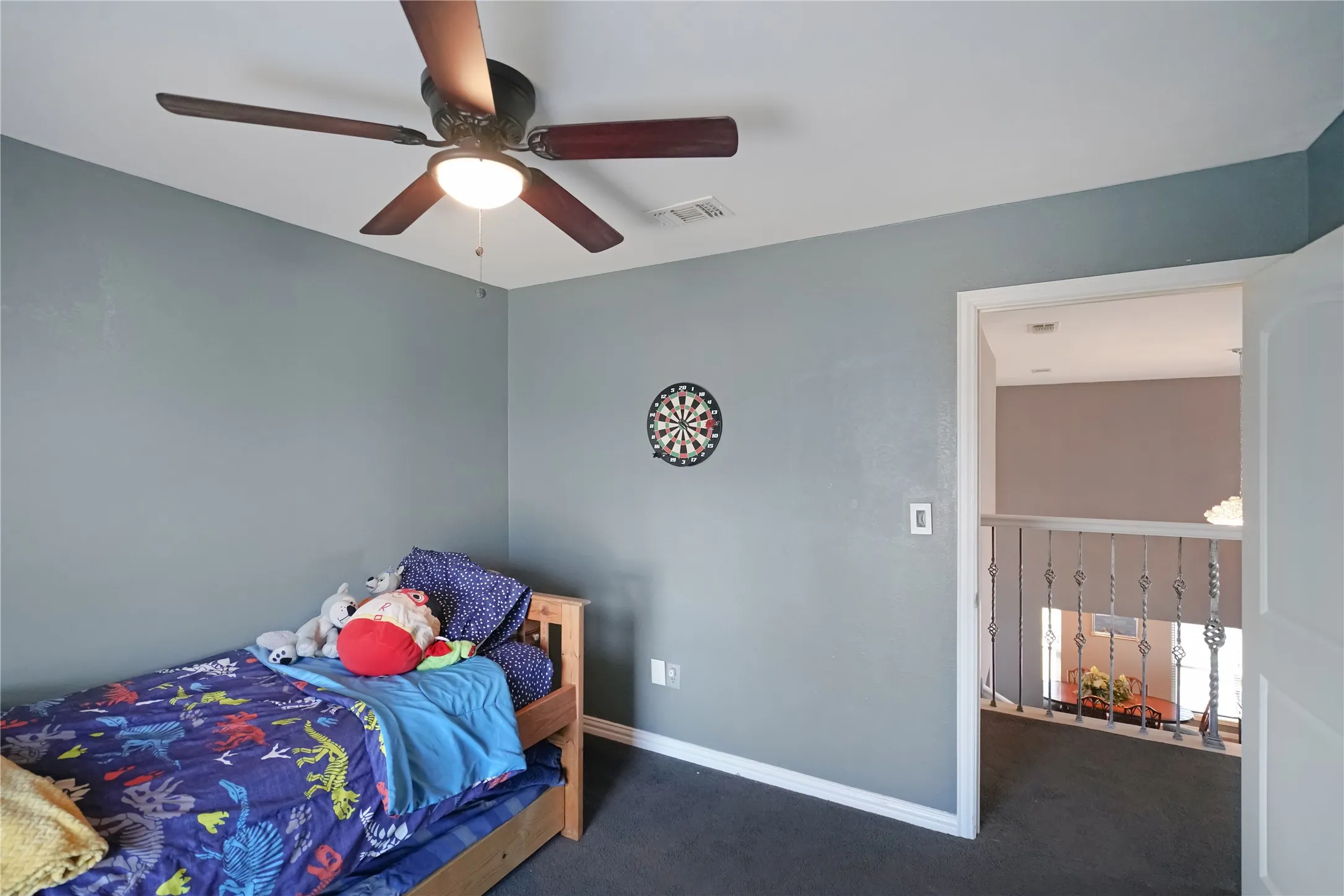 Carpeted bedroom with baseboards and ceiling fan