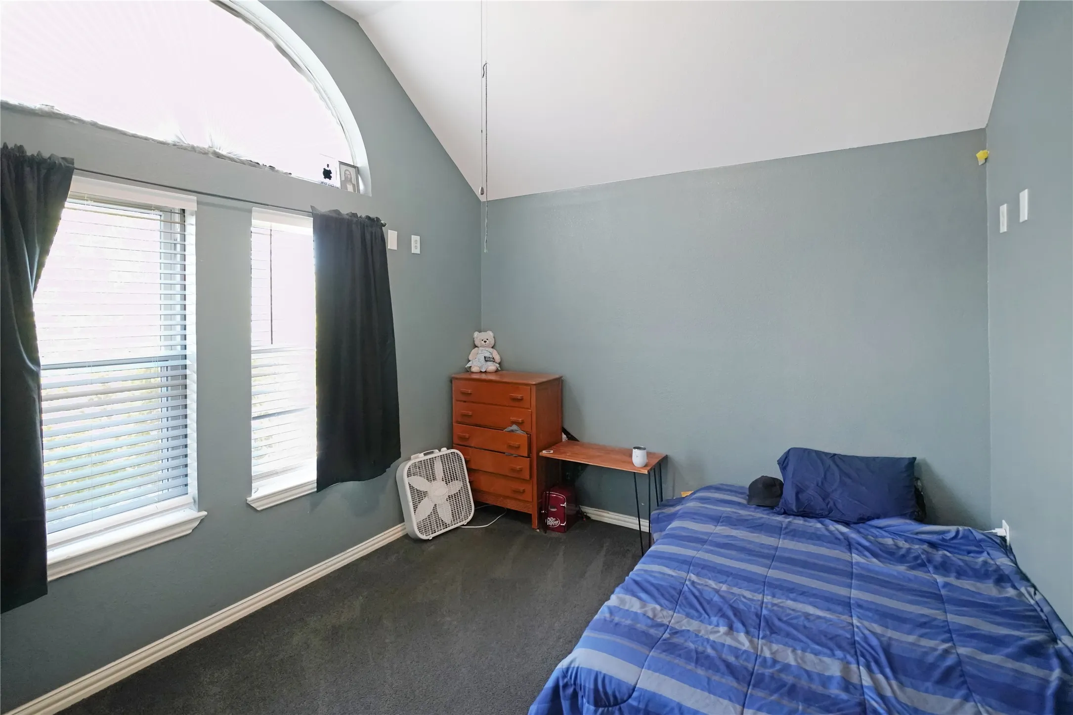 Bedroom featuring lofted ceiling and carpet flooring