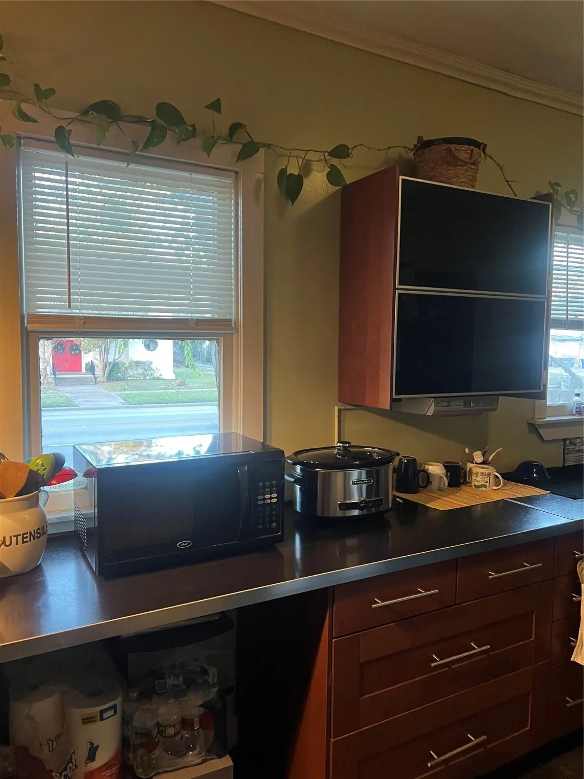 Kitchen with dark countertops and crown molding