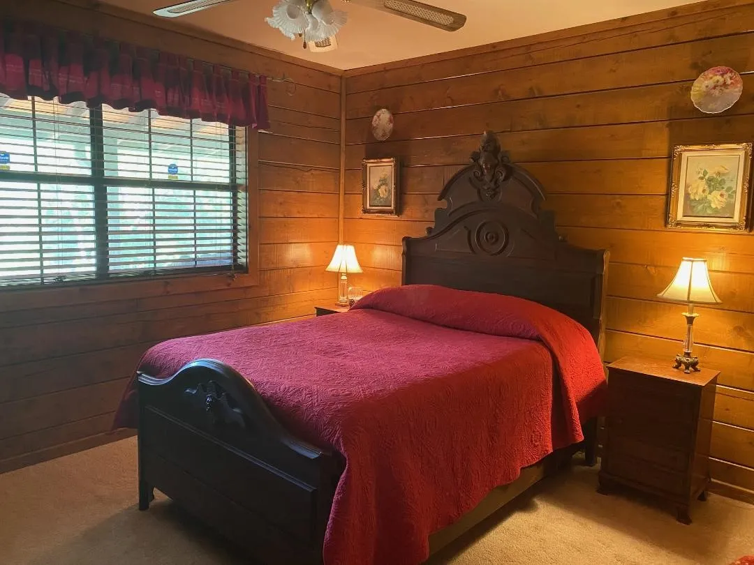 Carpeted bedroom featuring ceiling fan