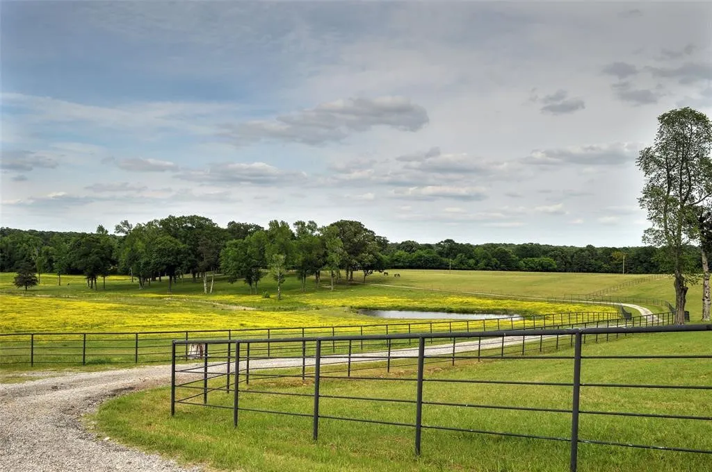 View of dirt / gravel road featuring a view of countryside and a water view
