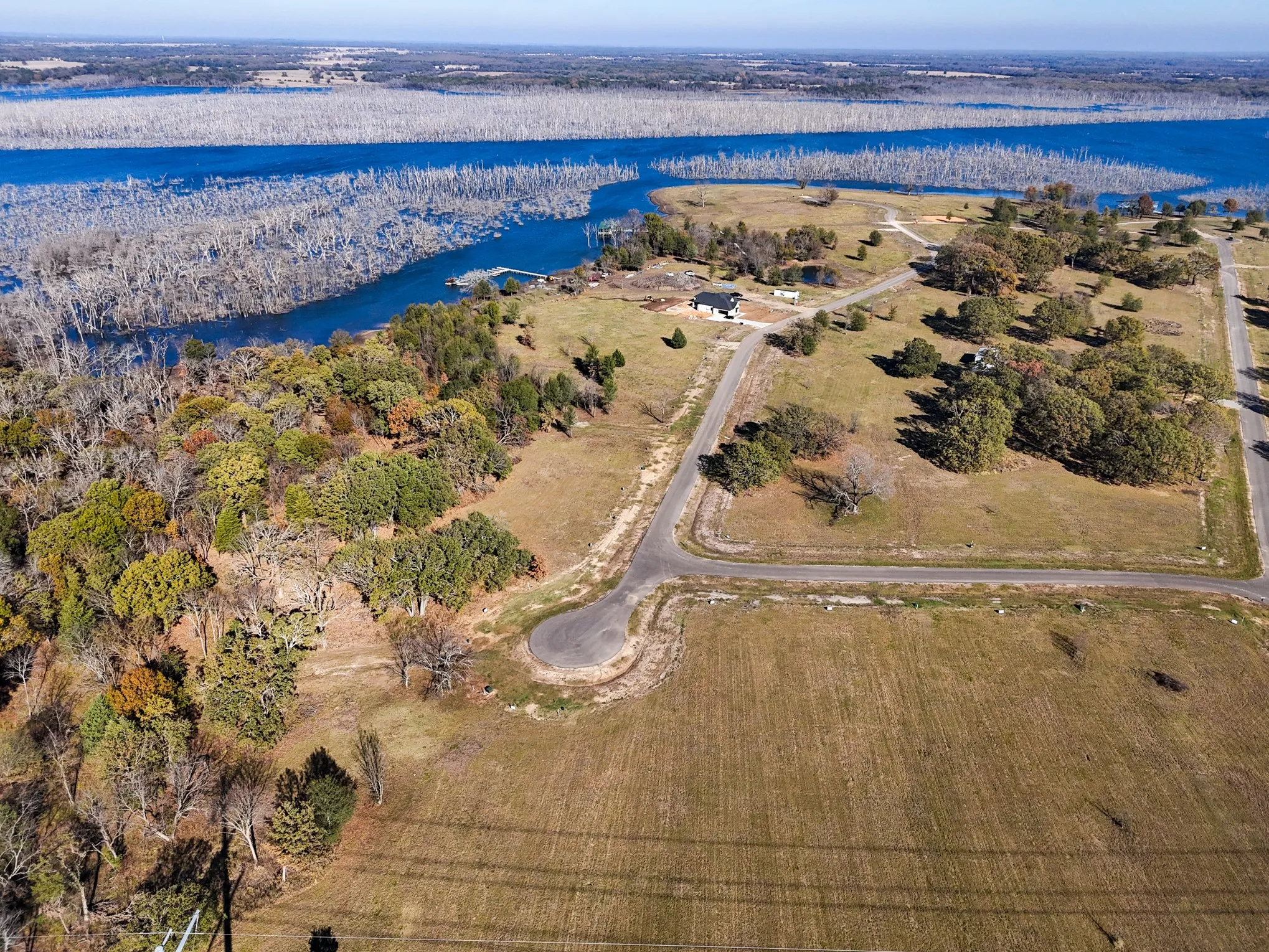 Aerial view of property's location with a nearby body of water
