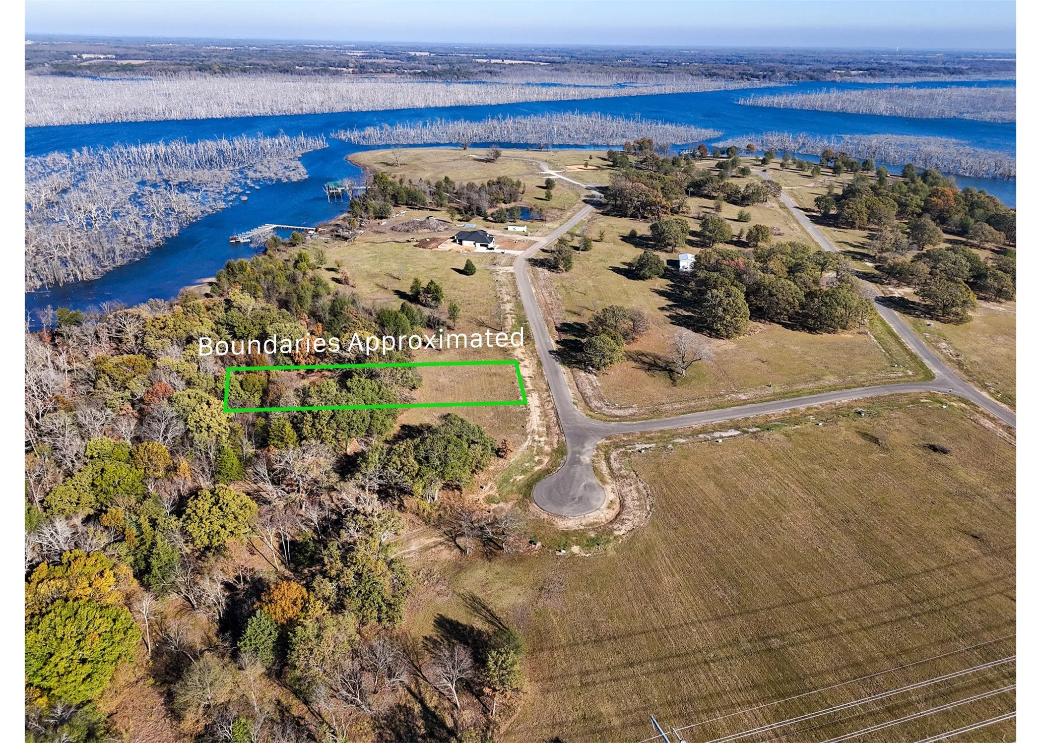 View of property location featuring property boundaries highlighted and a nearby body of water