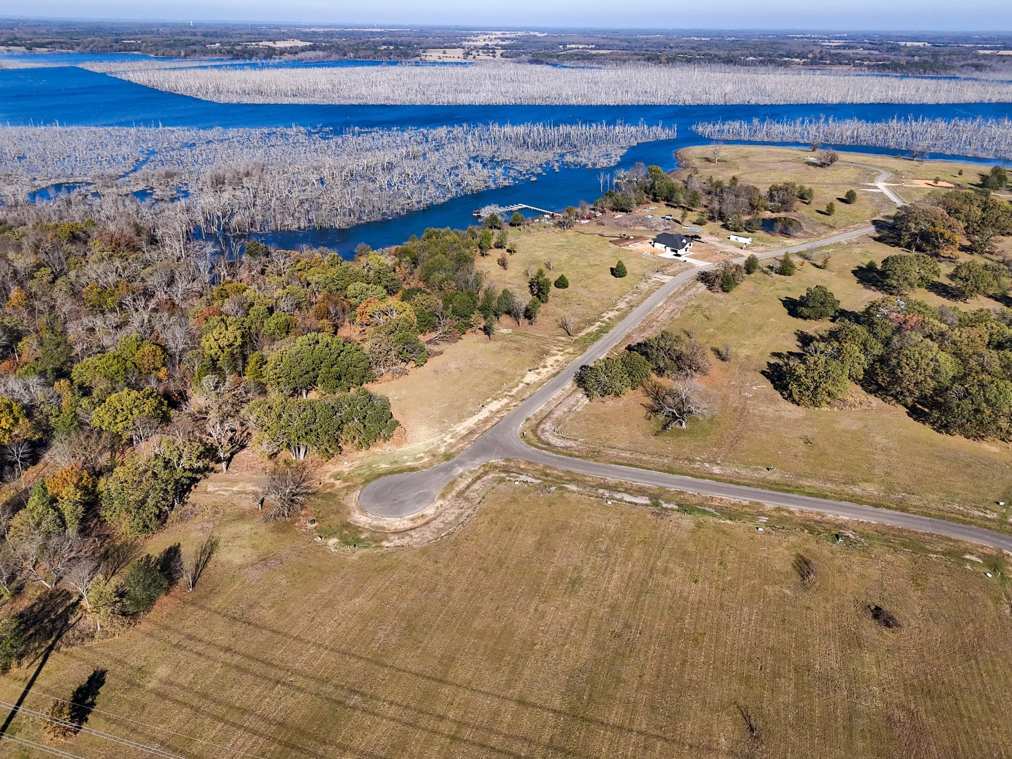 Aerial view of property and surrounding area featuring a nearby body of water