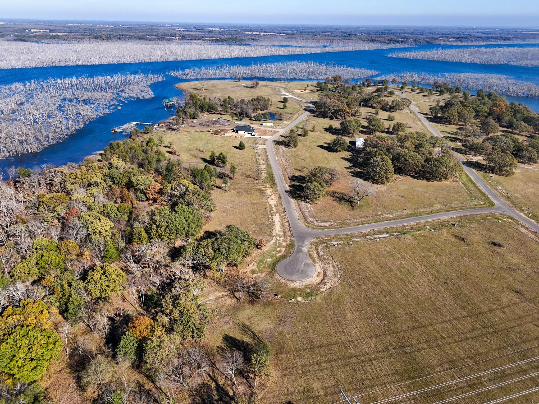 Aerial view of property and surrounding area with a large body of water