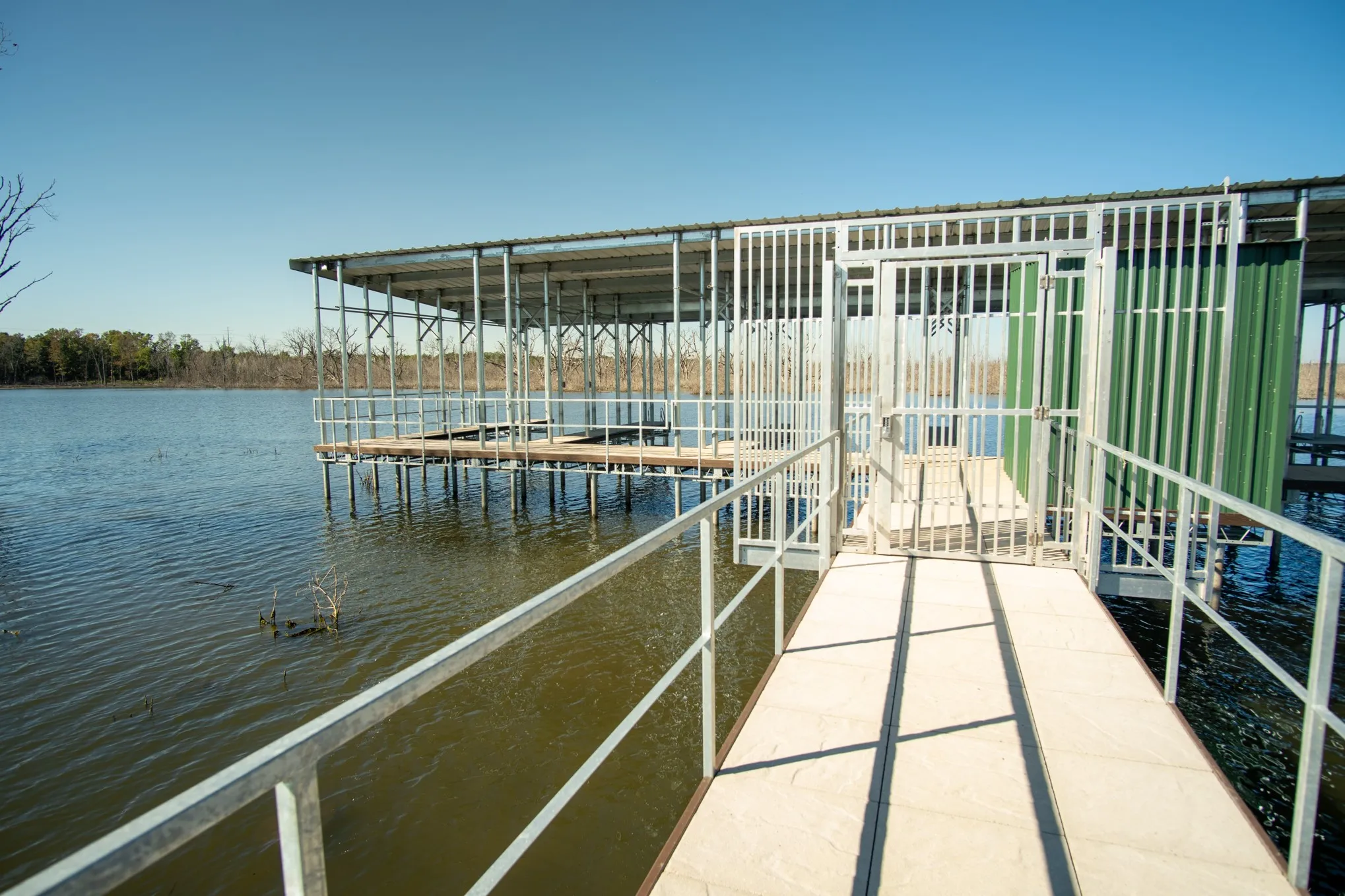 Dock area with a water view and boat lift