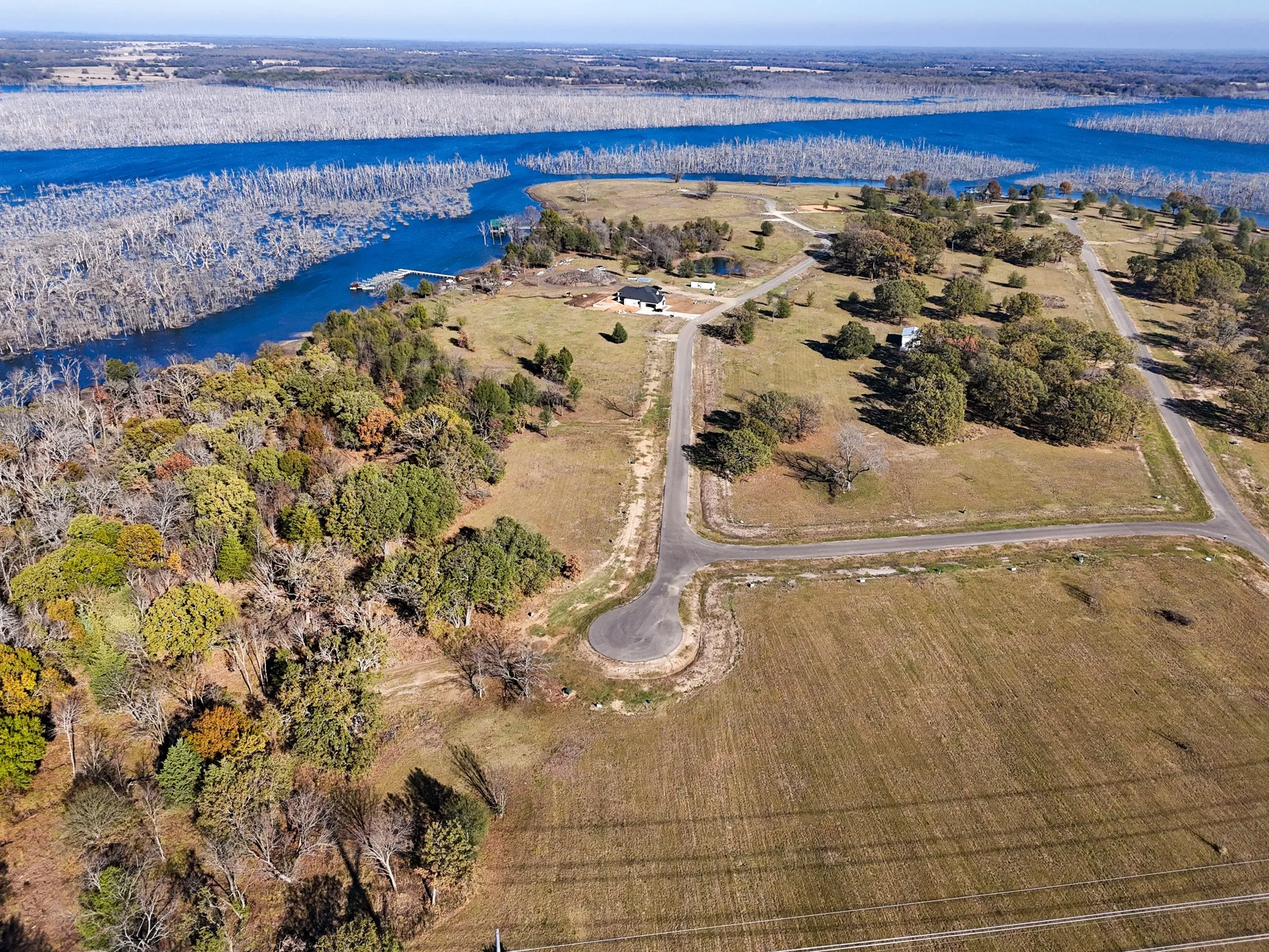 Aerial overview of property's location with a large body of water