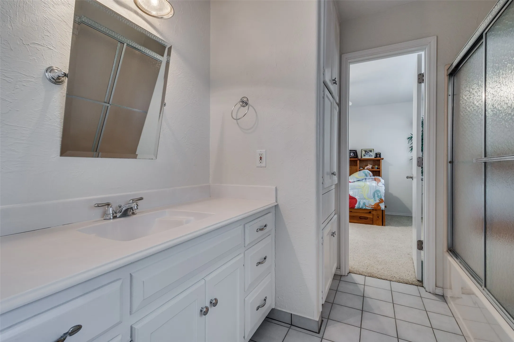 the second and third upstairs bedrooms are joined by this nice bath with lots of storage space.