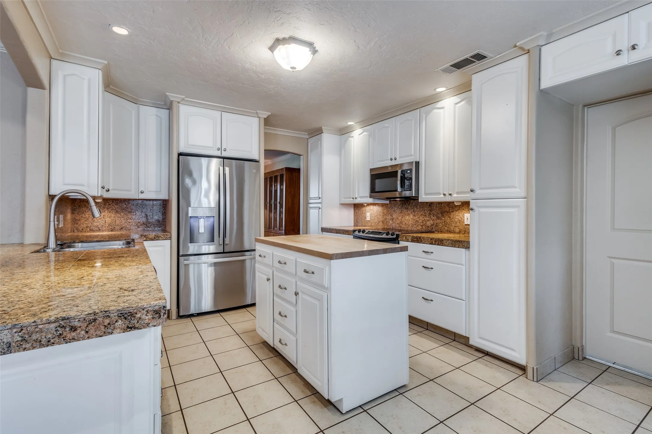 Another shot of kitchen with door to the right that enters the laundry room