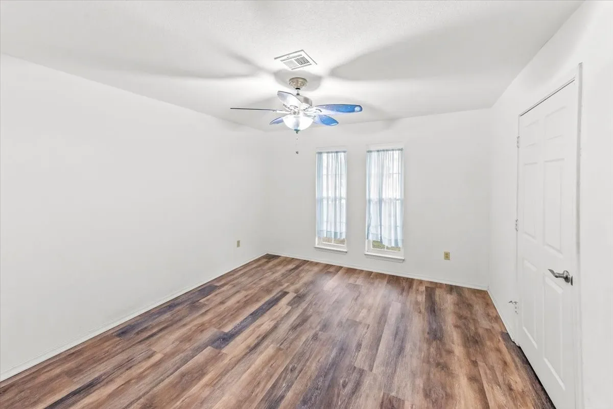 Empty room featuring a ceiling fan and vinyl  floors