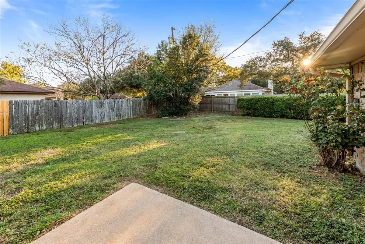 Fenced backyard with a patio area
