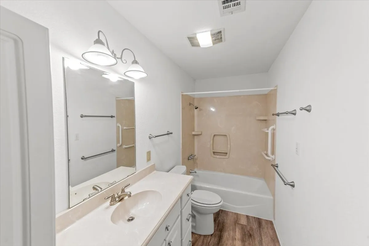 Bathroom with vanity,  shower combination, and vinyl flooring