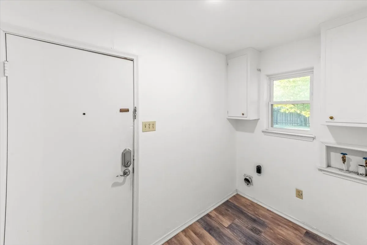 Laundry with vynil flooring, cabinet space, and washer hookup