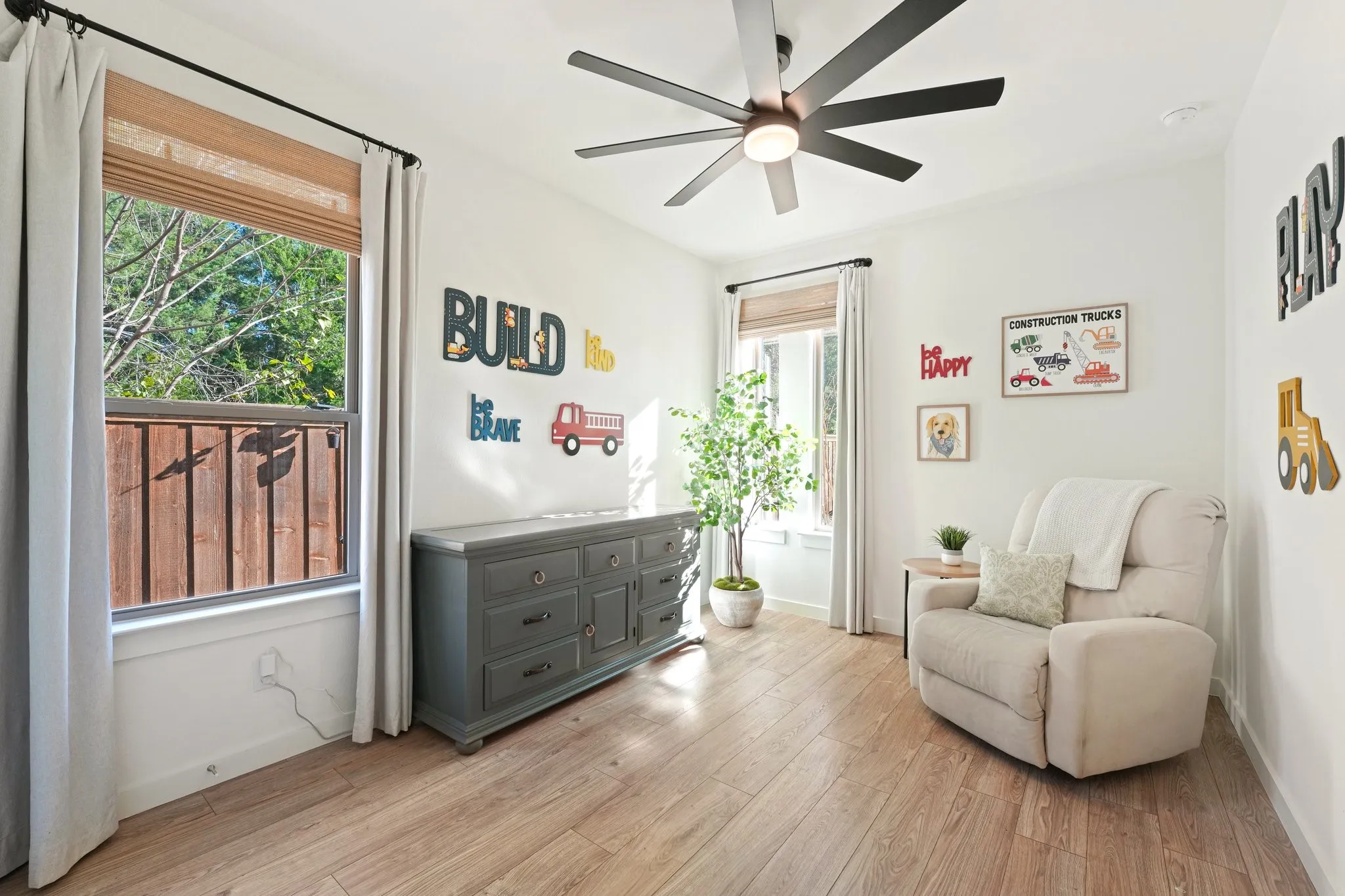 Living area featuring light wood finished floors and a ceiling fan