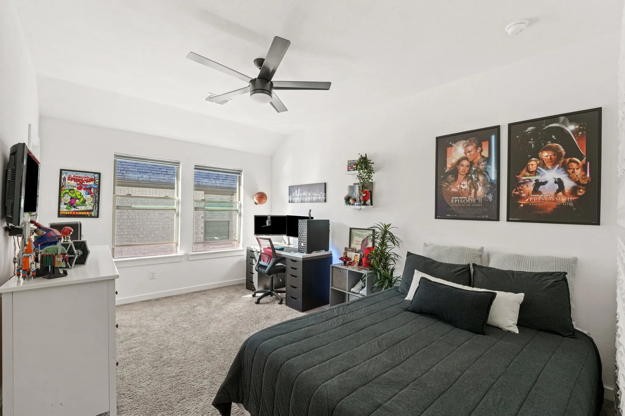 Bedroom featuring light colored carpet, a ceiling fan, an office area, and lofted ceiling