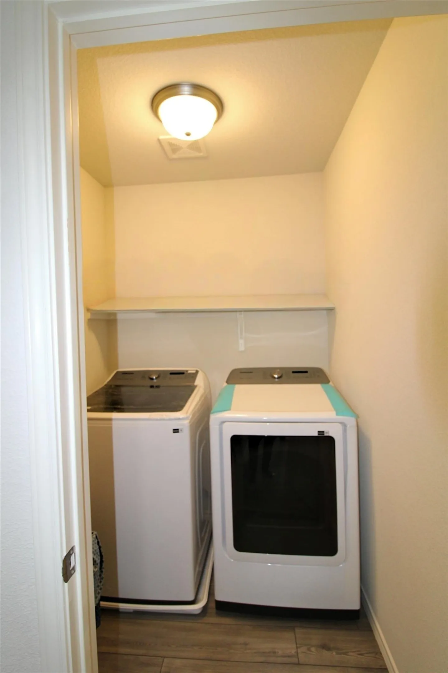 Laundry area with dark wood-style flooring and washer and dryer