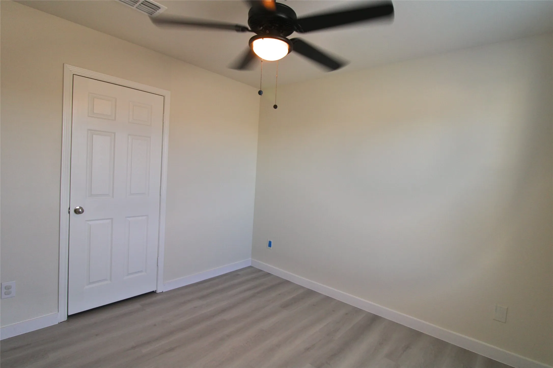 Unfurnished bedroom featuring light wood-type flooring and ceiling fan