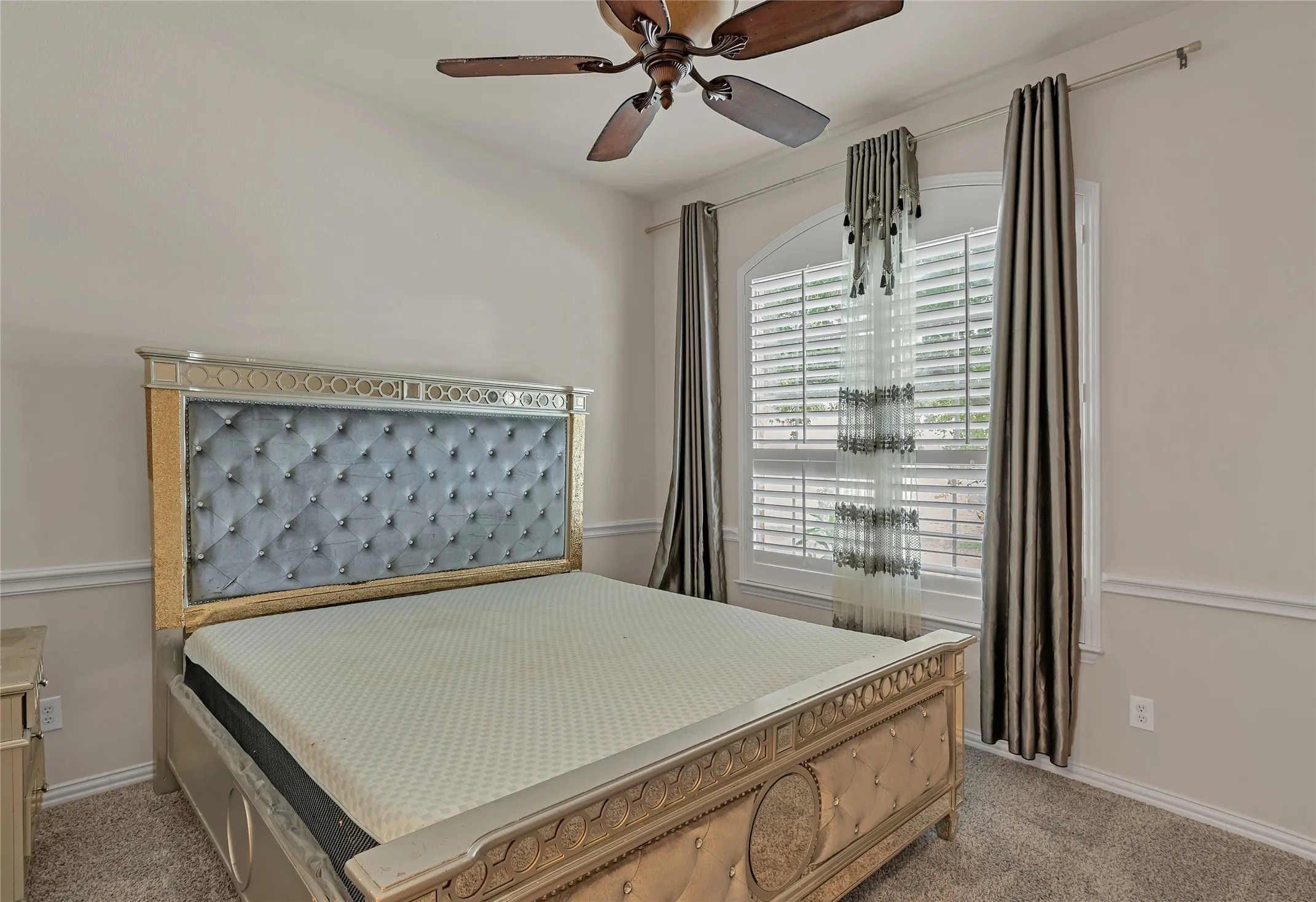 Bedroom with light colored carpet and ceiling fan