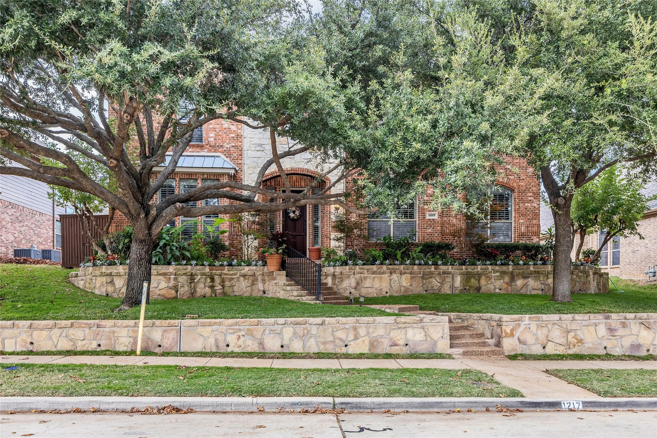 View of front facade with brick siding and a front yard