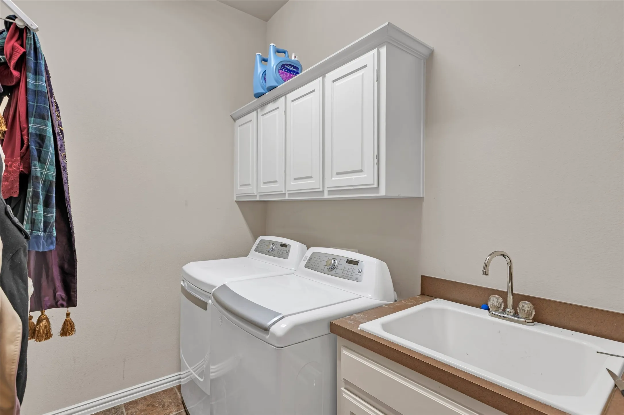 Laundry room with washing machine and dryer and cabinet space