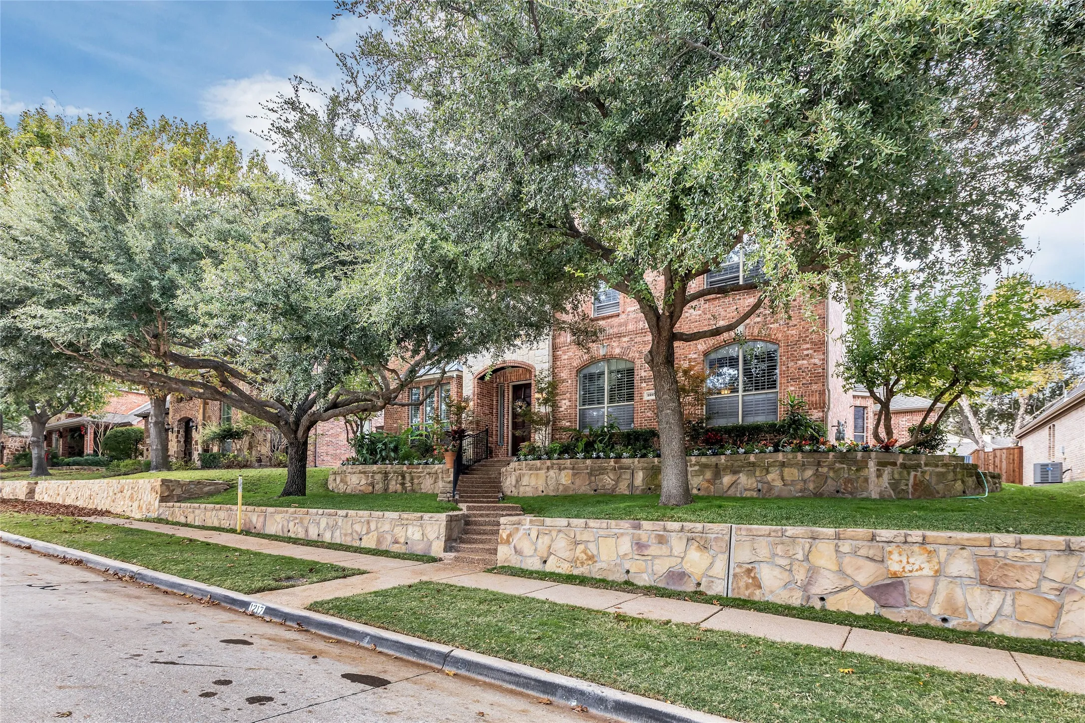 View of front of house featuring brick siding and a front lawn