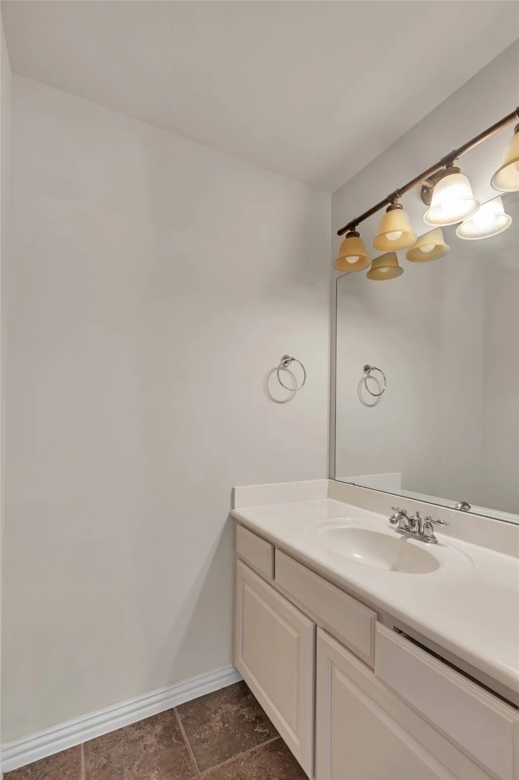 Bathroom featuring vanity and baseboards