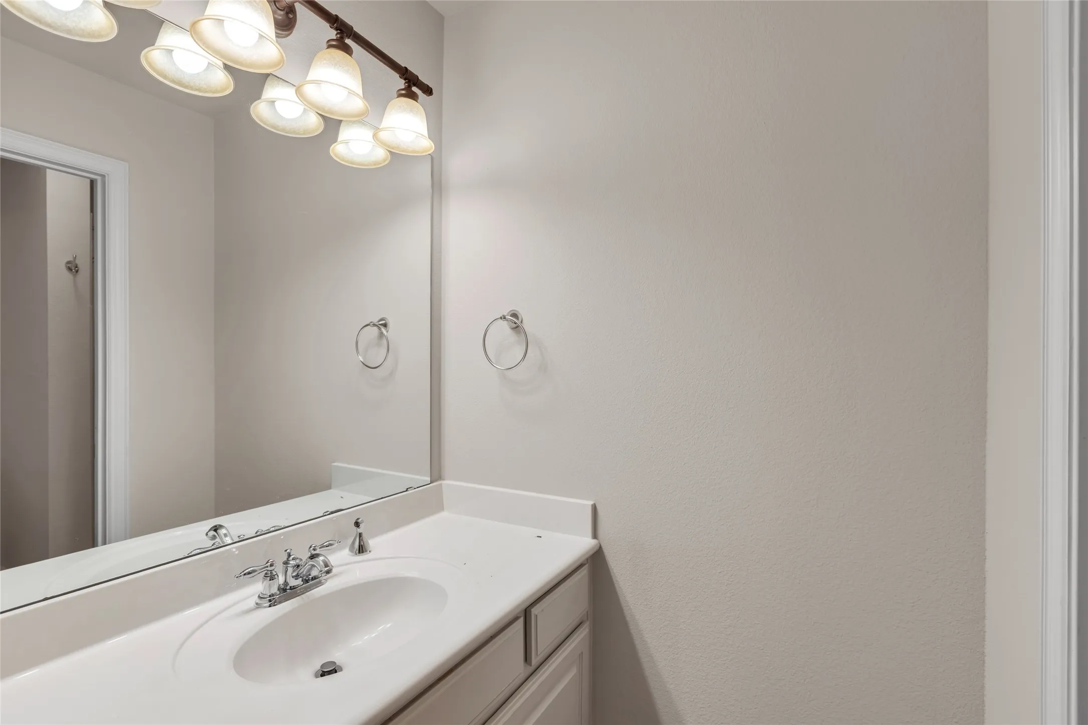 Bathroom featuring vanity and a chandelier
