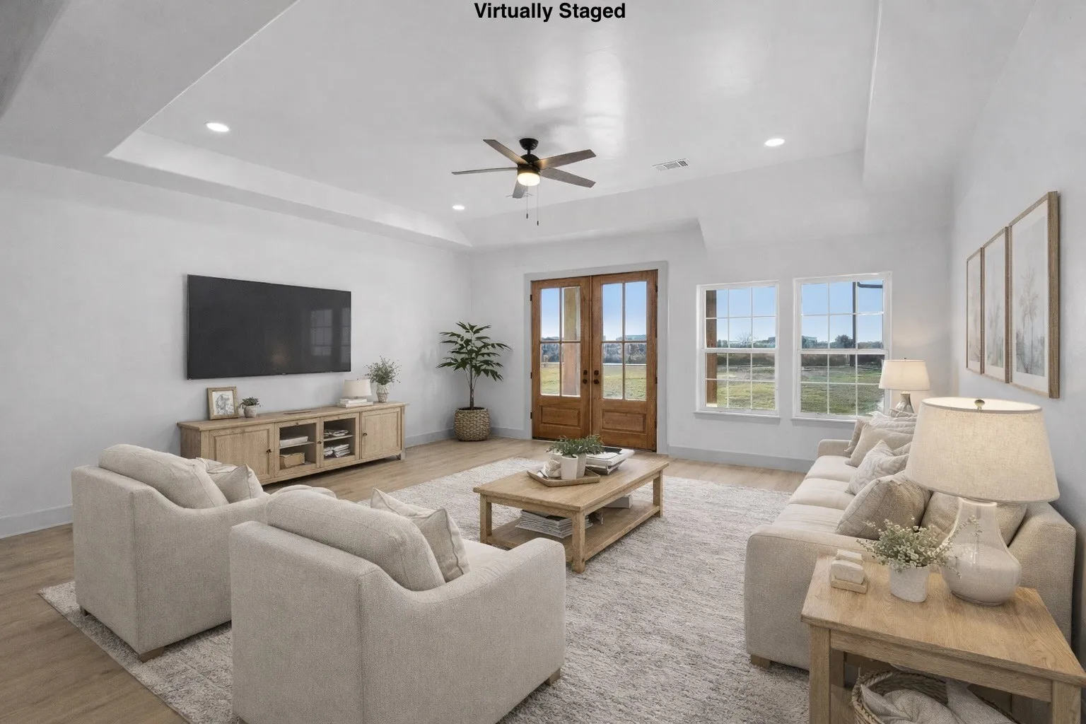 Living room featuring ceiling fan, light wood-style flooring, french doors, a raised ceiling, and recessed lighting