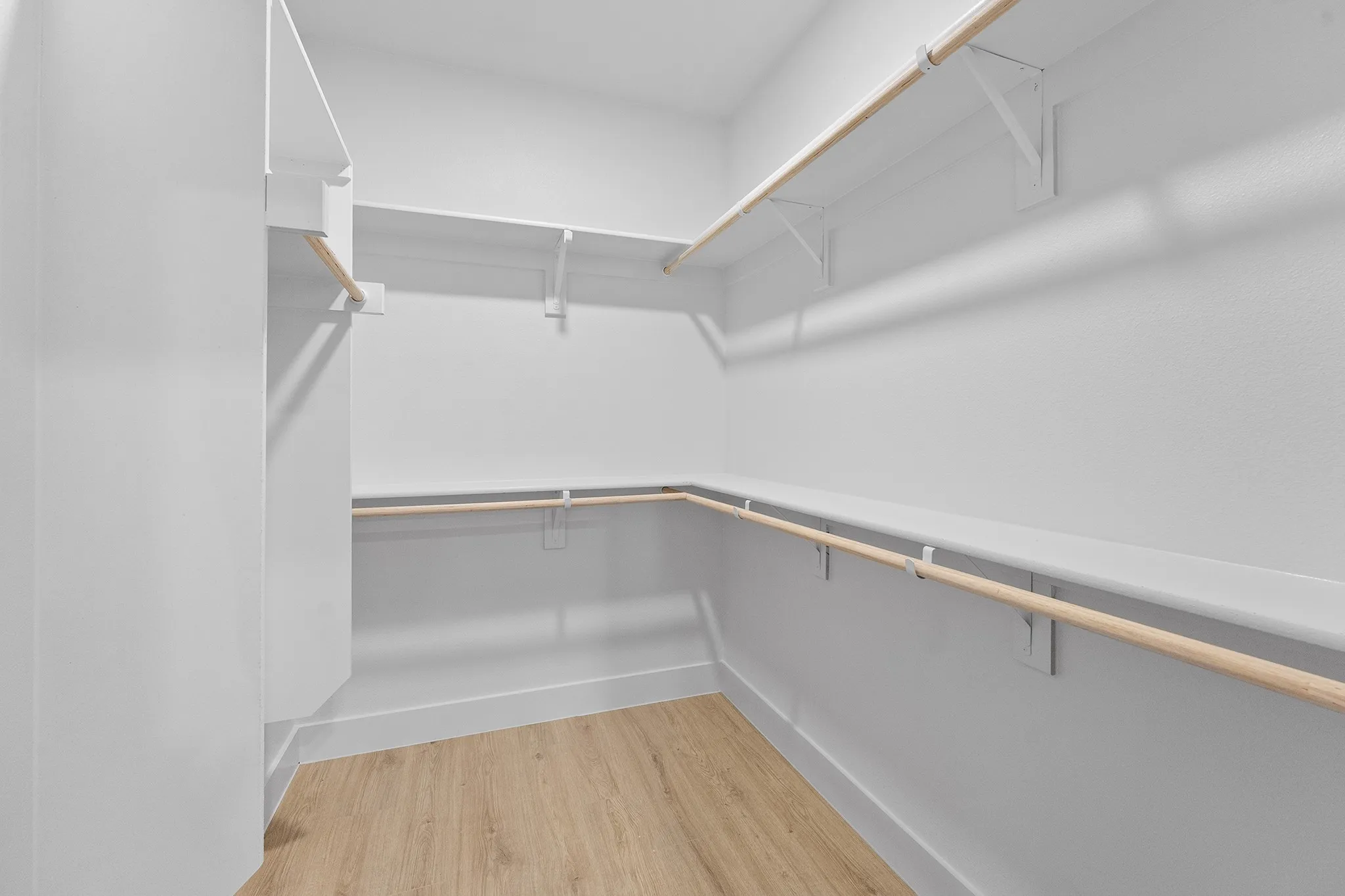 Spacious closet with light wood-style flooring