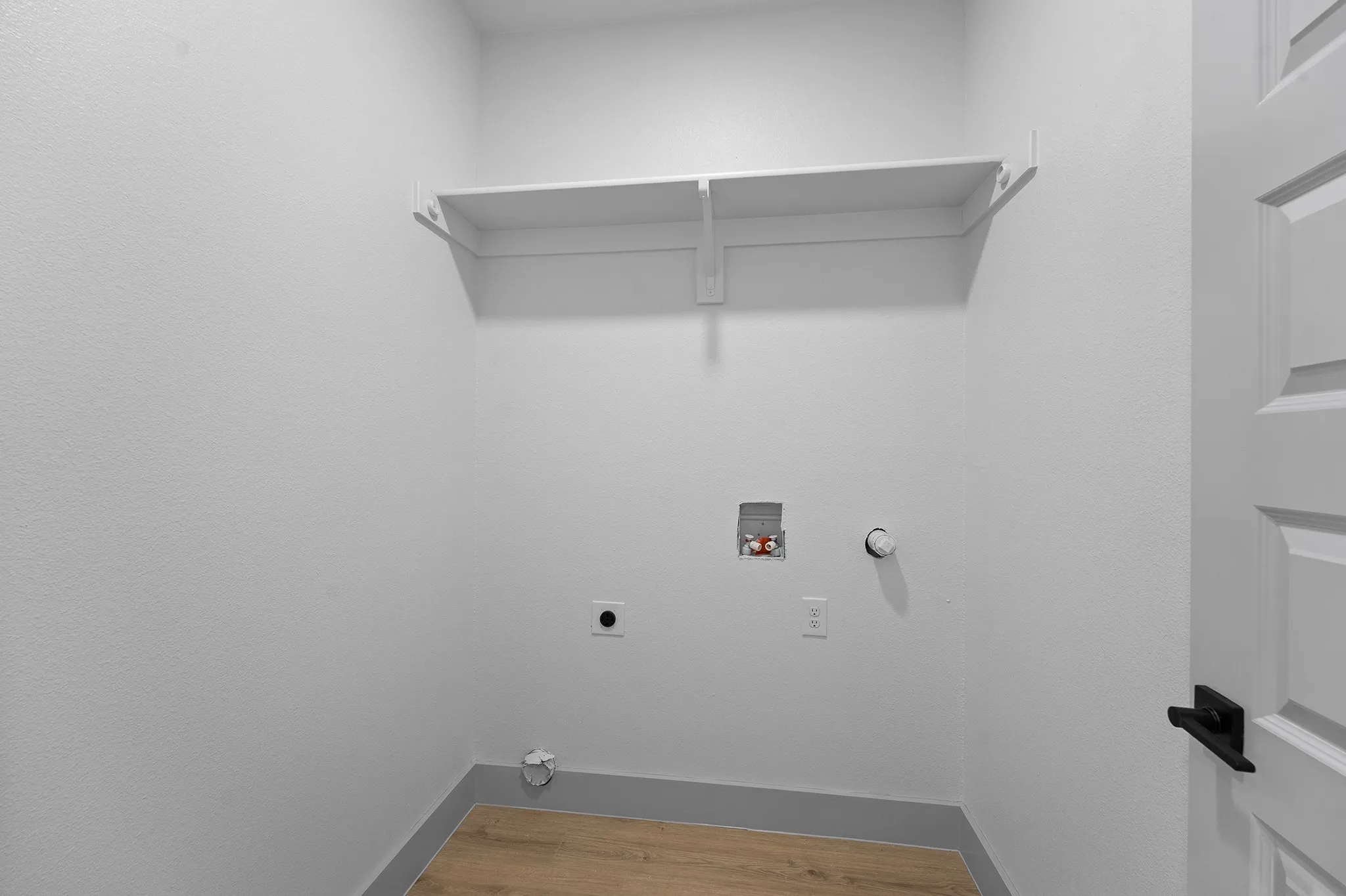 Washroom featuring electric dryer hookup, washer hookup, hookup for a gas dryer, and wood finished floors