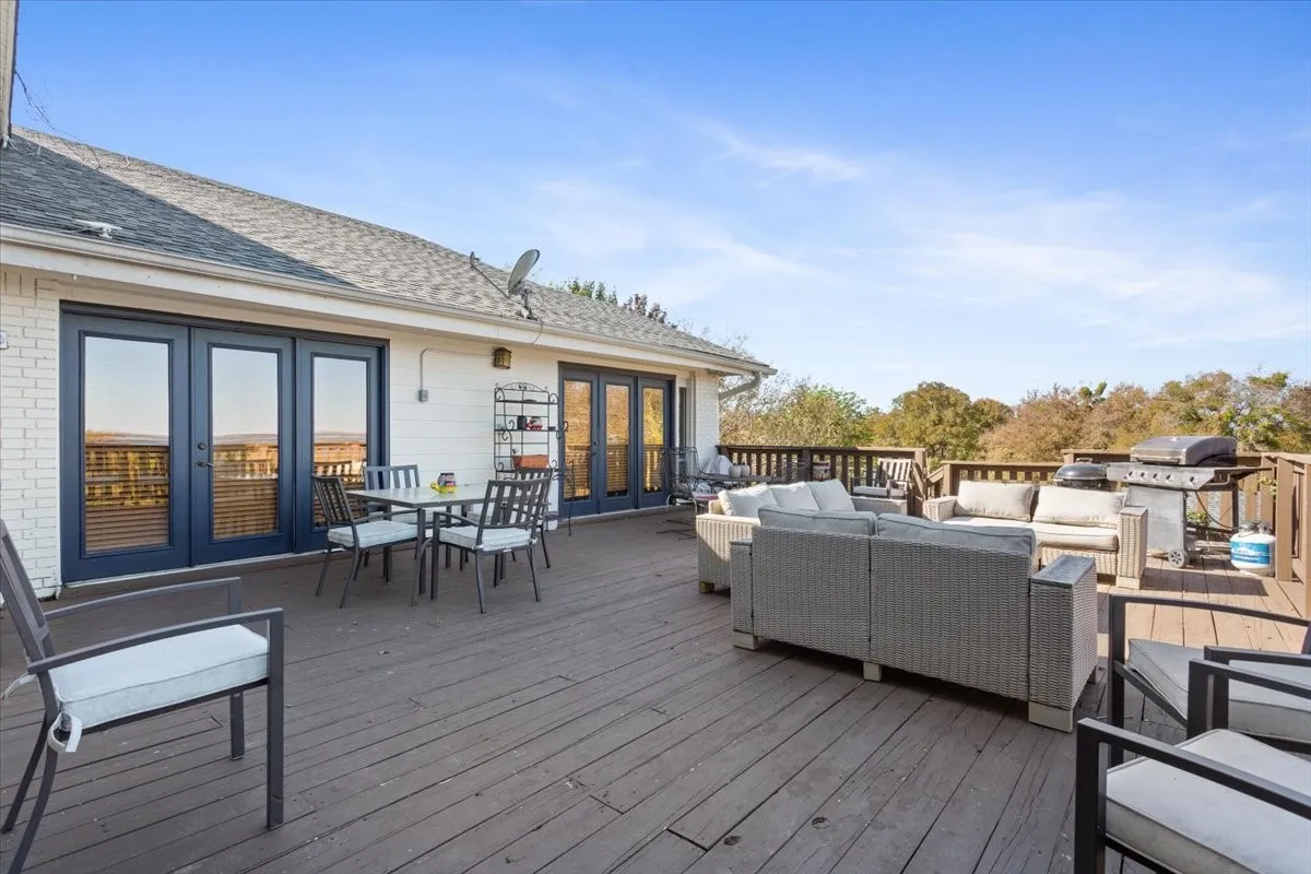Wooden terrace featuring french doors, an outdoor living space, and outdoor dining space
