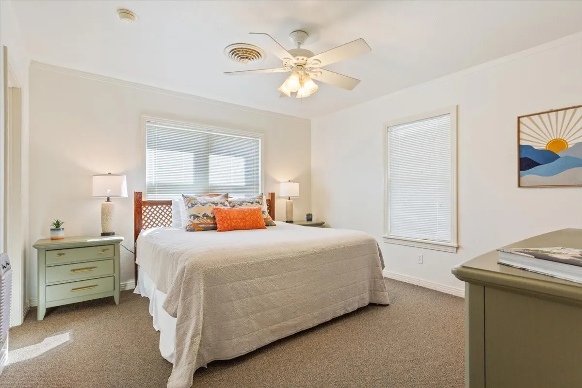 Bedroom with ornamental molding, carpet, and ceiling fan