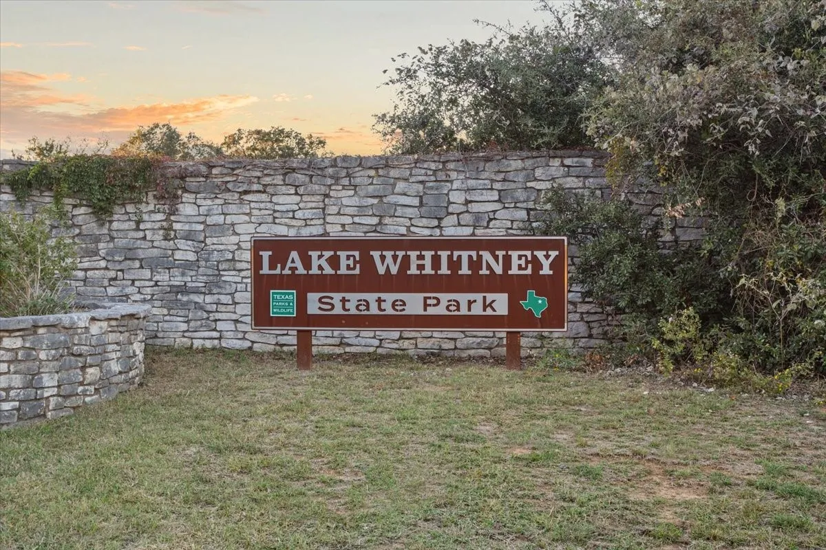 Community / neighborhood sign with a yard