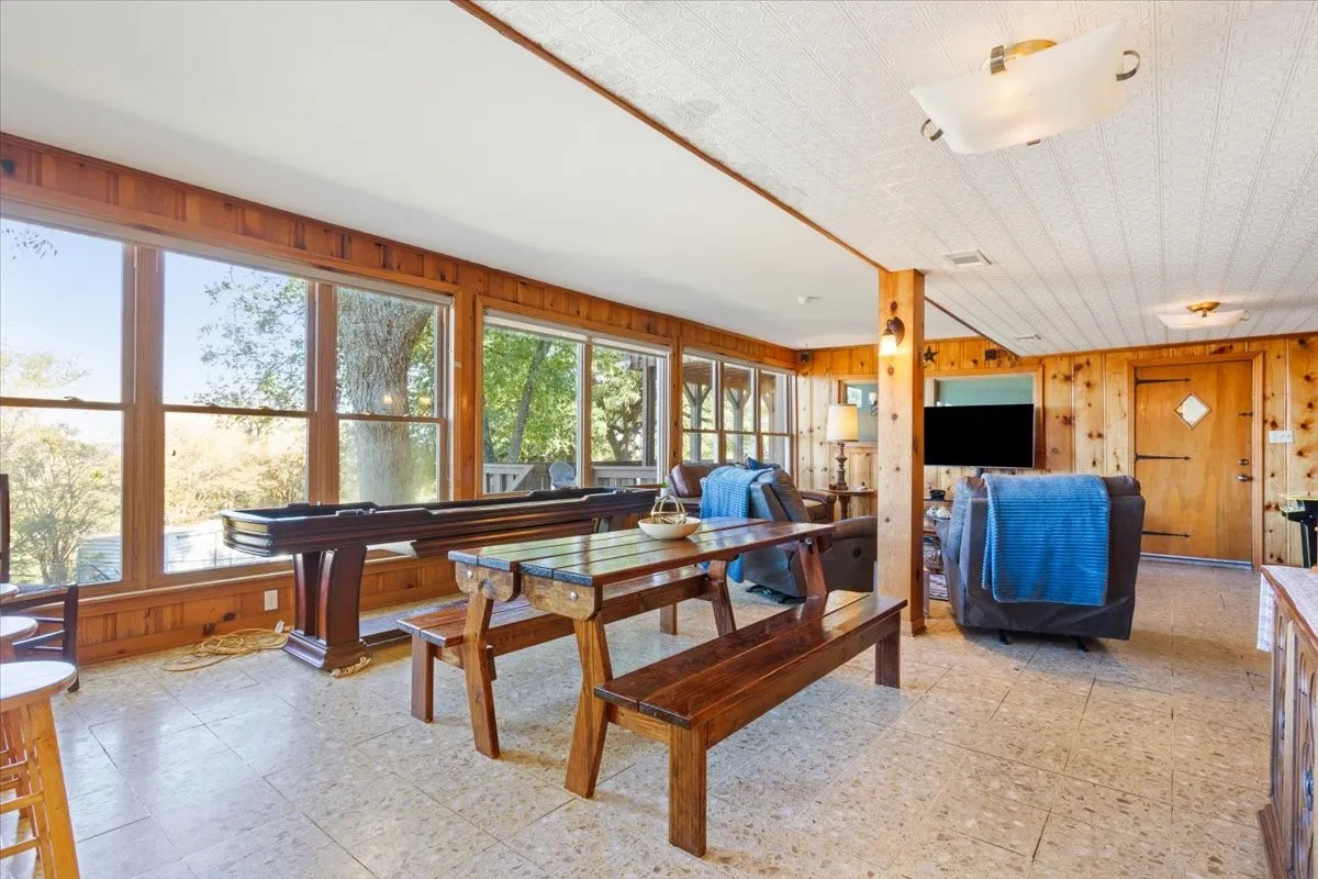 Dining space with wood walls and light flooring