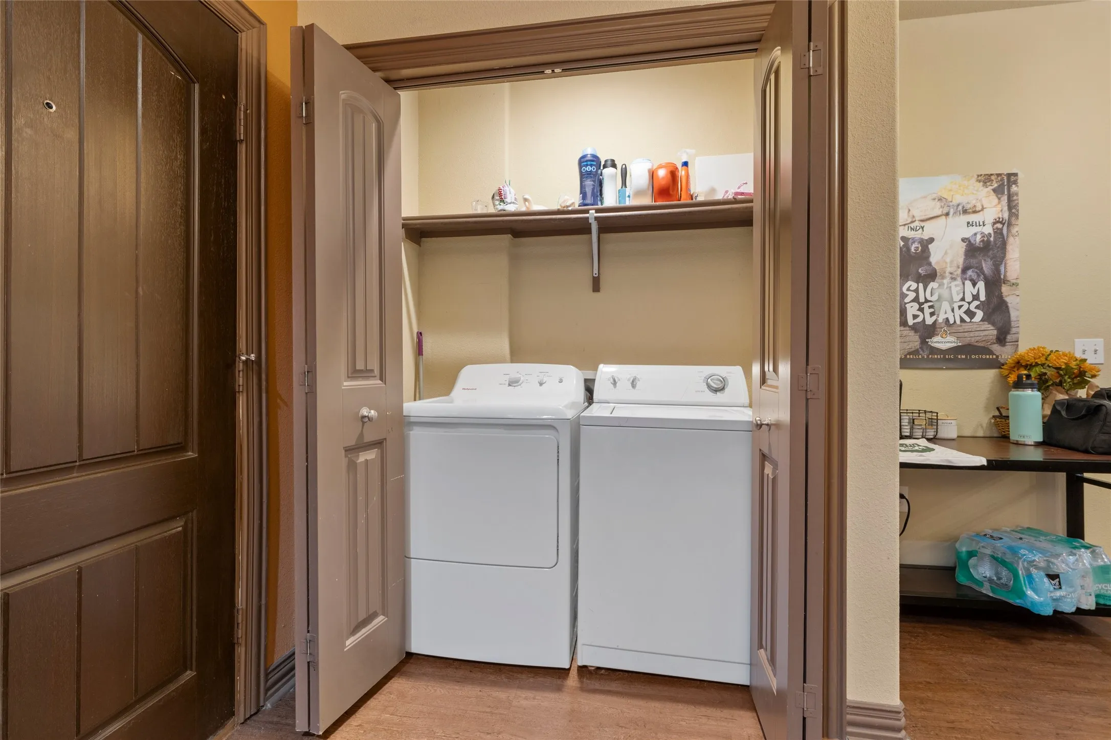 Washroom with light wood finished floors and washer and clothes dryer