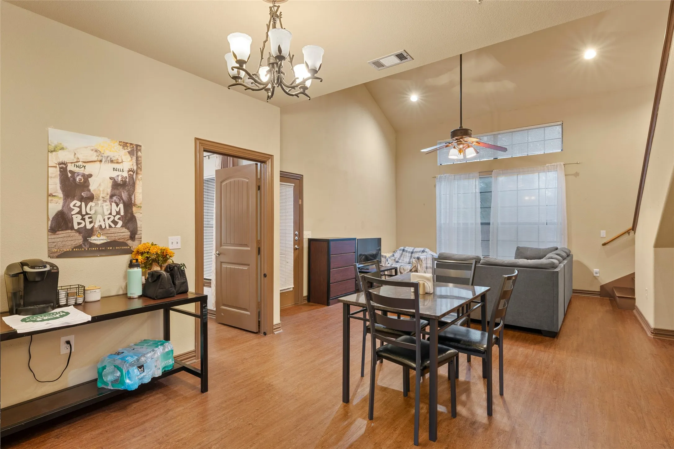 Dining area with a chandelier, light wood-style flooring, high vaulted ceiling, a ceiling fan, and recessed lighting