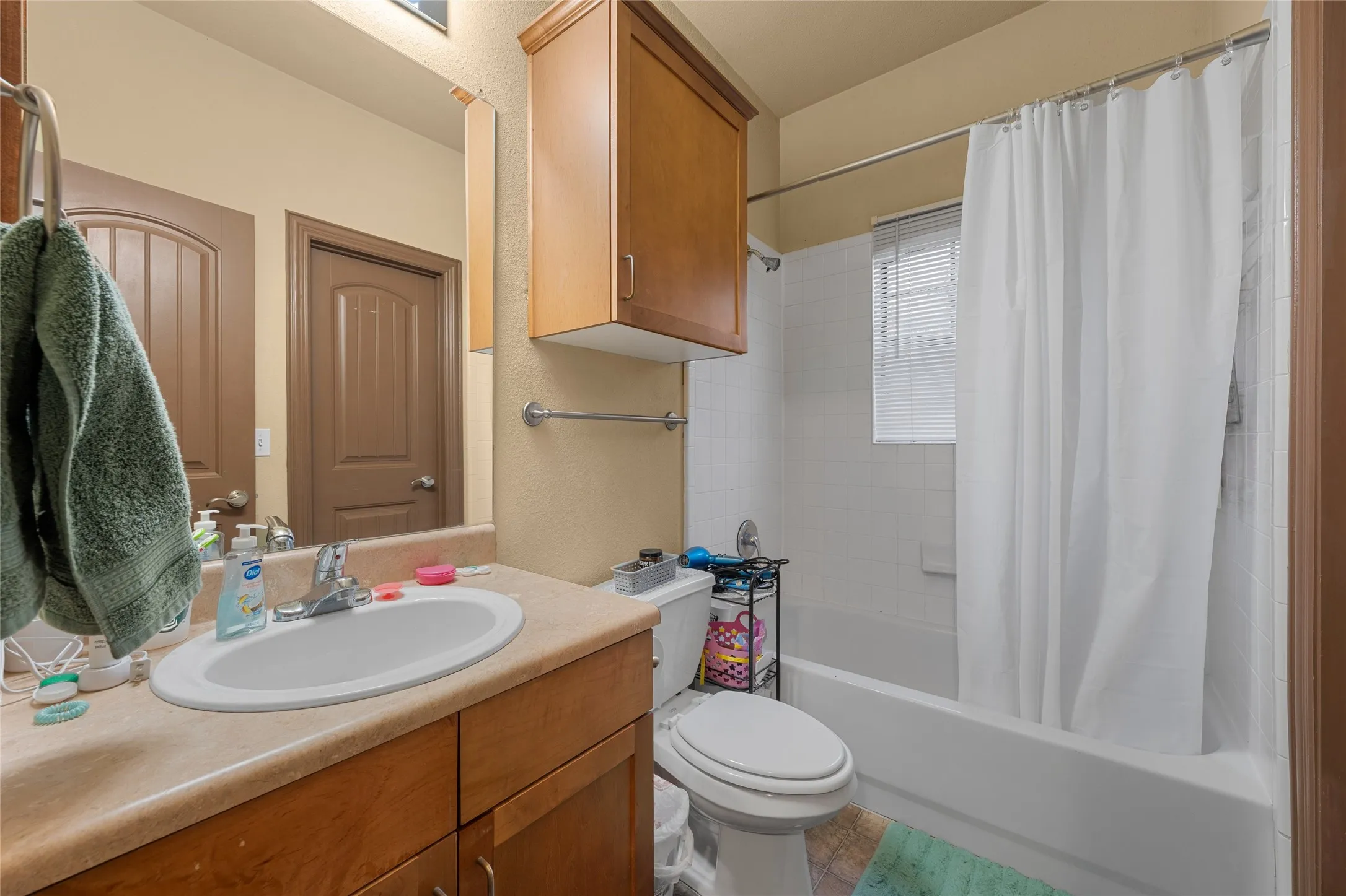 Bathroom featuring shower / tub combo and vanity