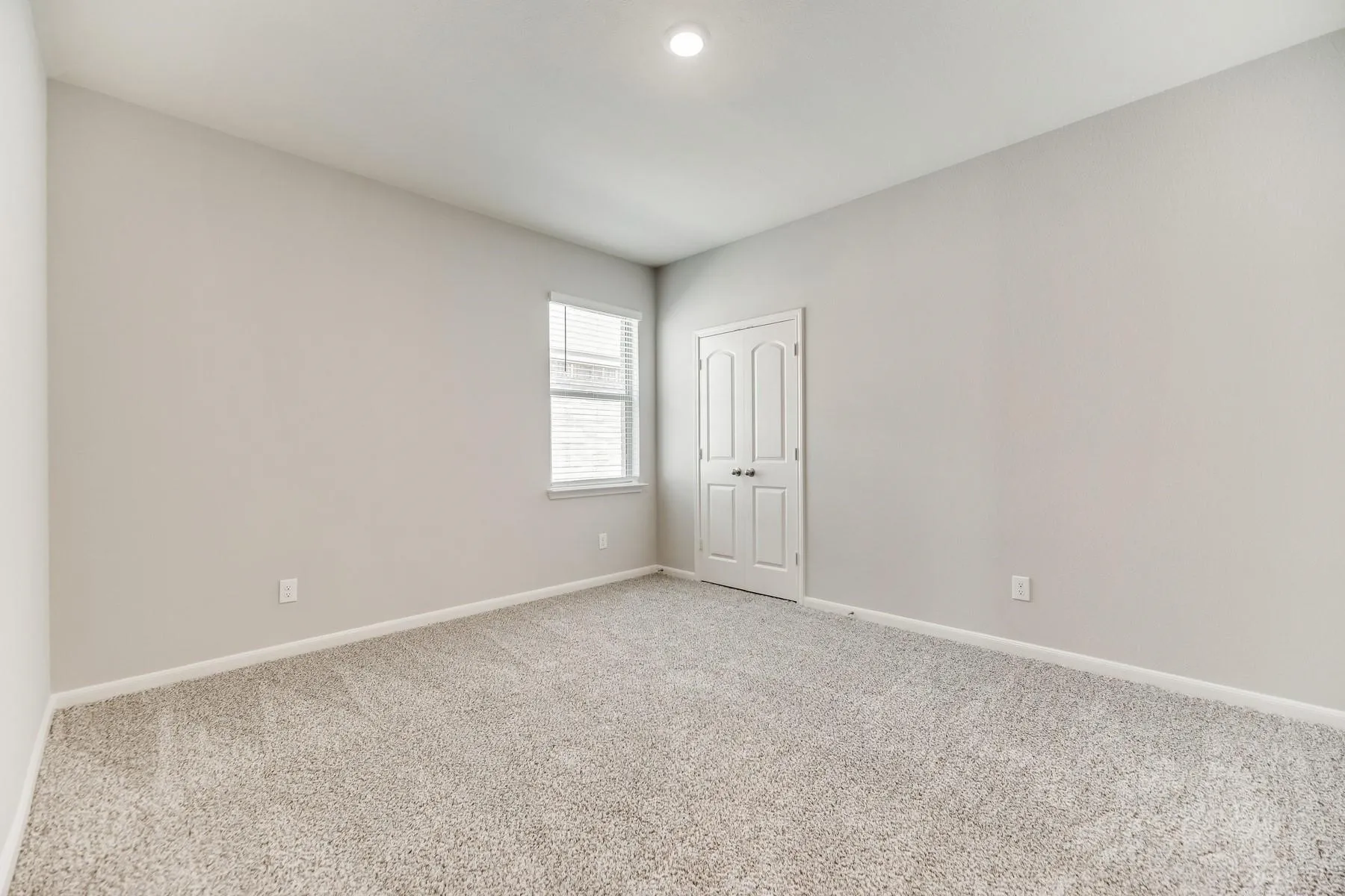 Carpeted spare room with baseboards