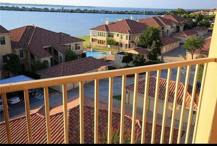Balcony featuring a residential view and a water view