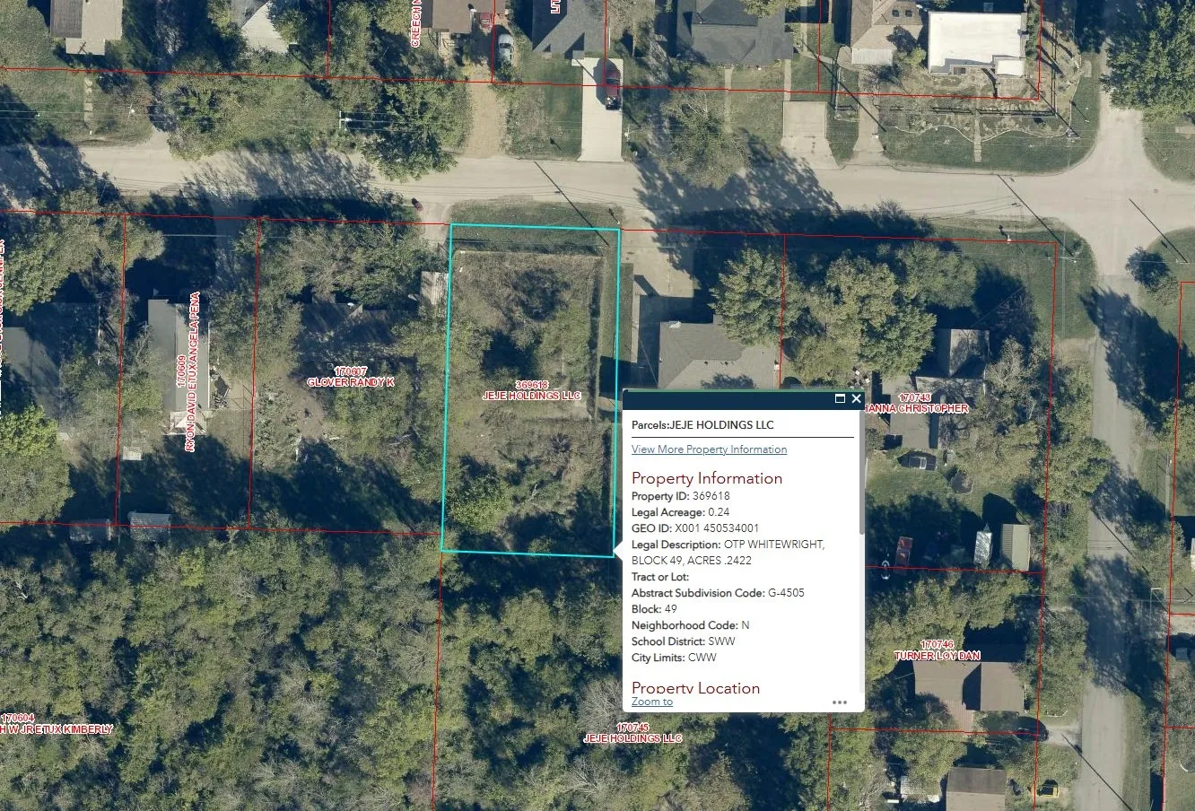 Aerial map of property and surrounding area featuring property boundaries highlighted