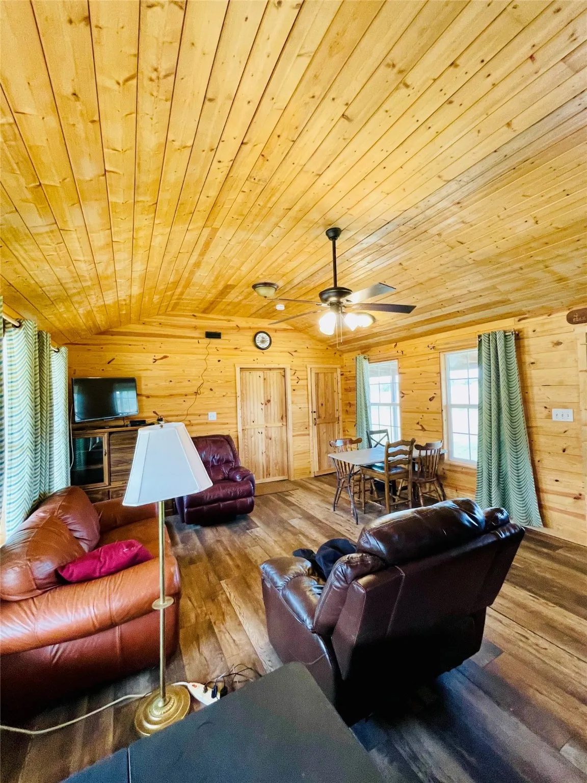 Living room with wooden ceiling, wood walls