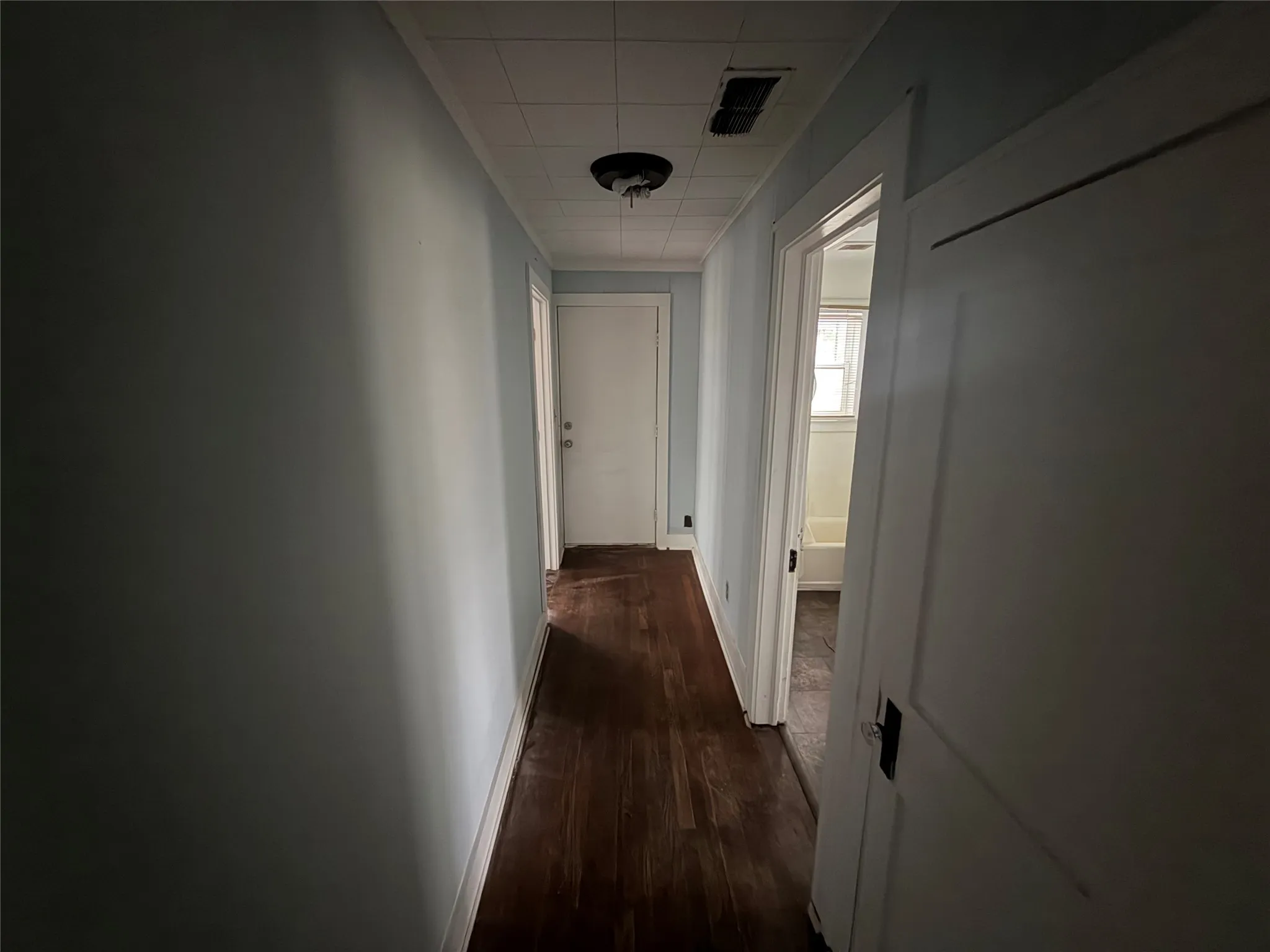 Corridor with baseboards and dark wood finished floors