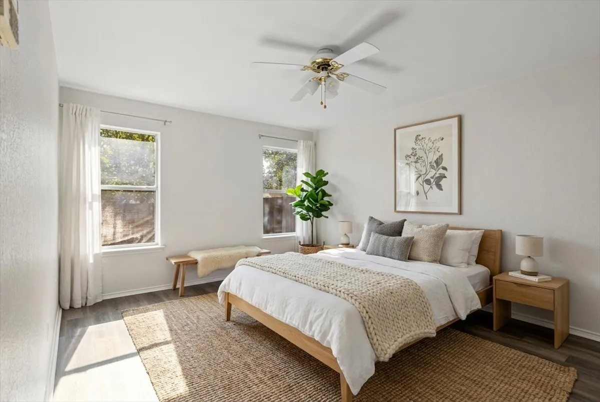 Bedroom with ceiling fan and wood finished floors- Virtually Staged