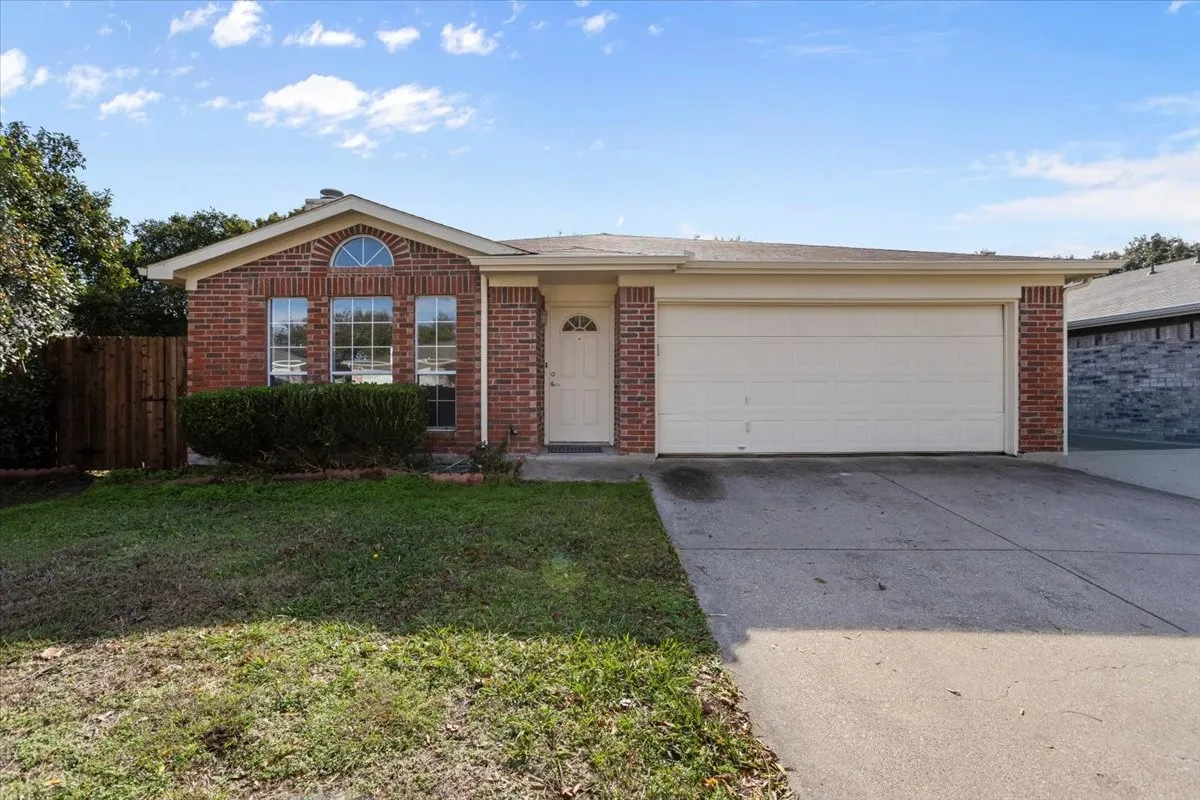 Ranch-style house with brick siding, concrete driveway, and an attached garage