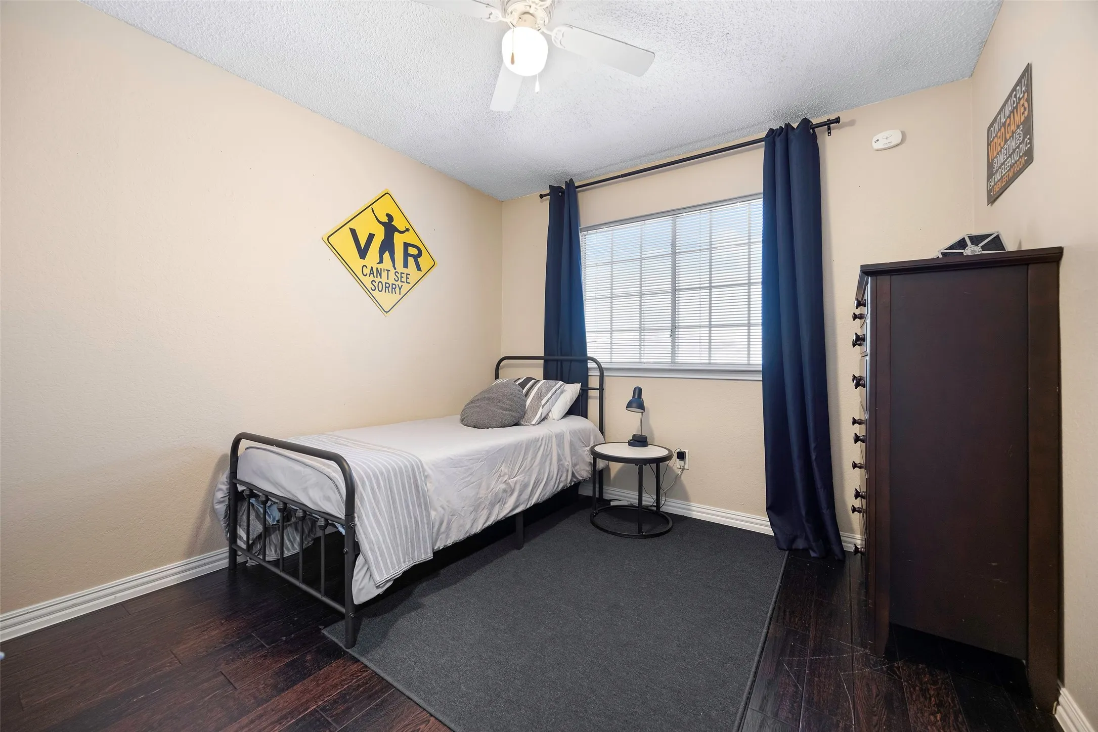Secondary bedroom #1 with walk in closet and wood floors