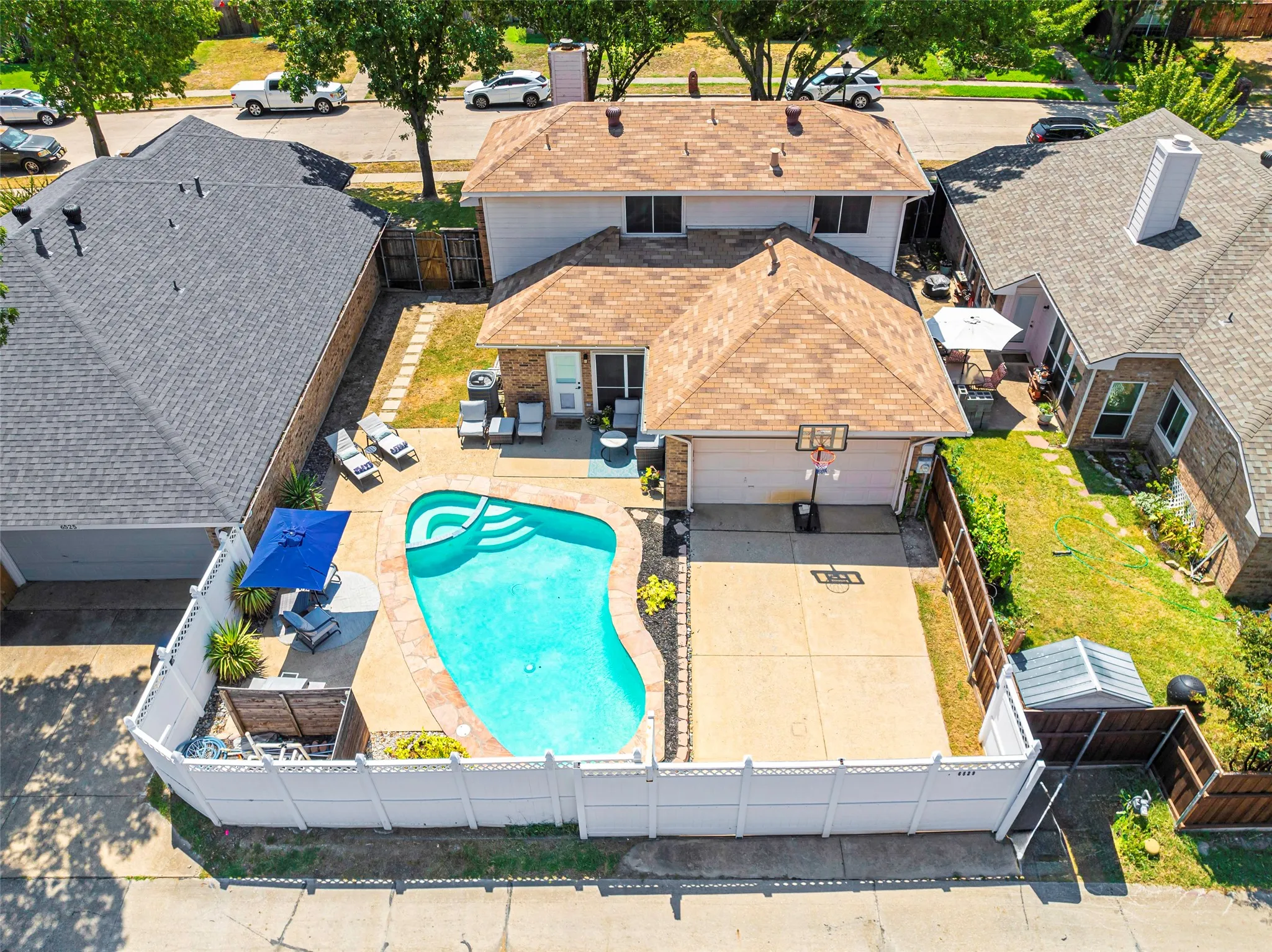 Aerial view of this home and backyard space