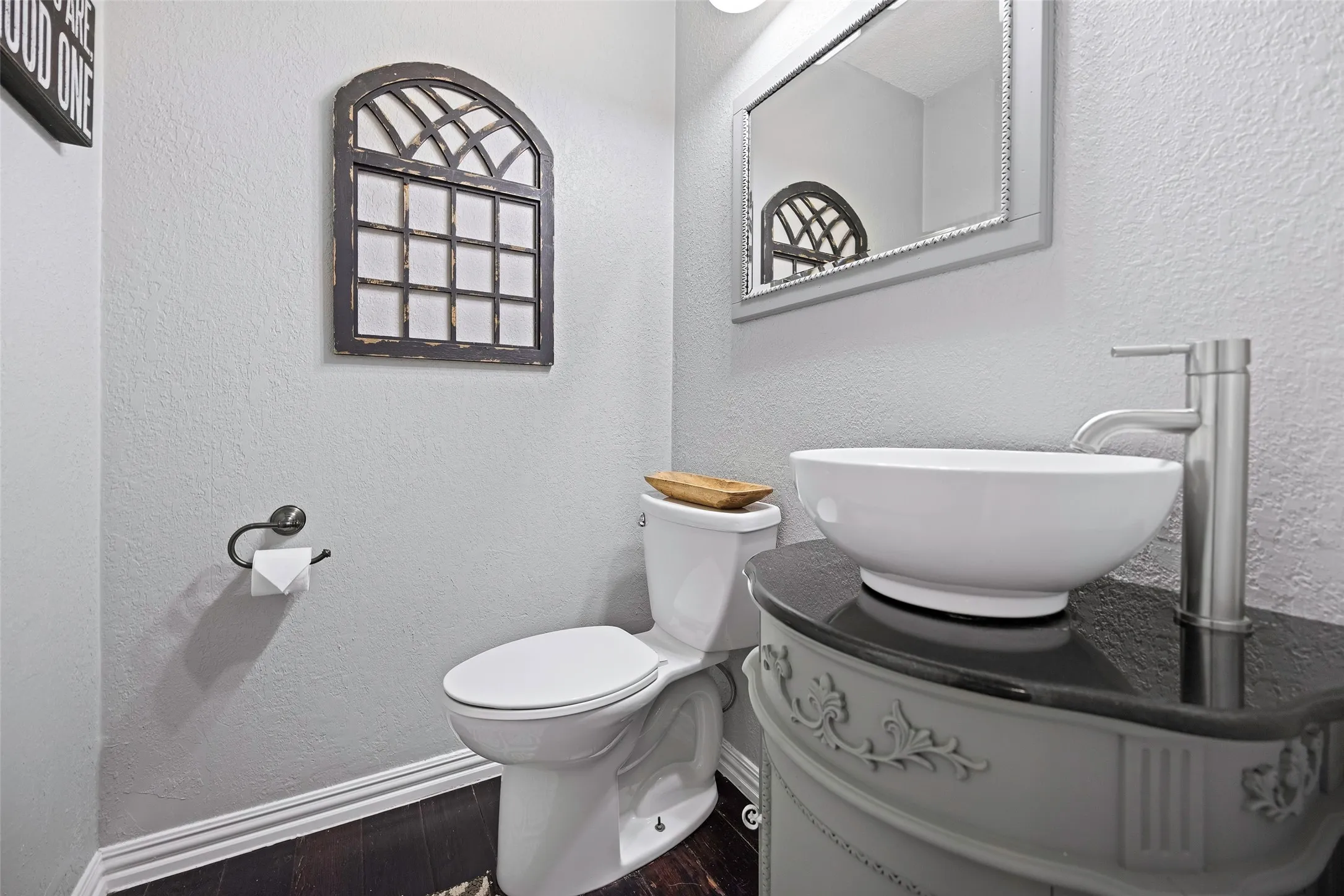 Half bath located outside the primary suite and living area