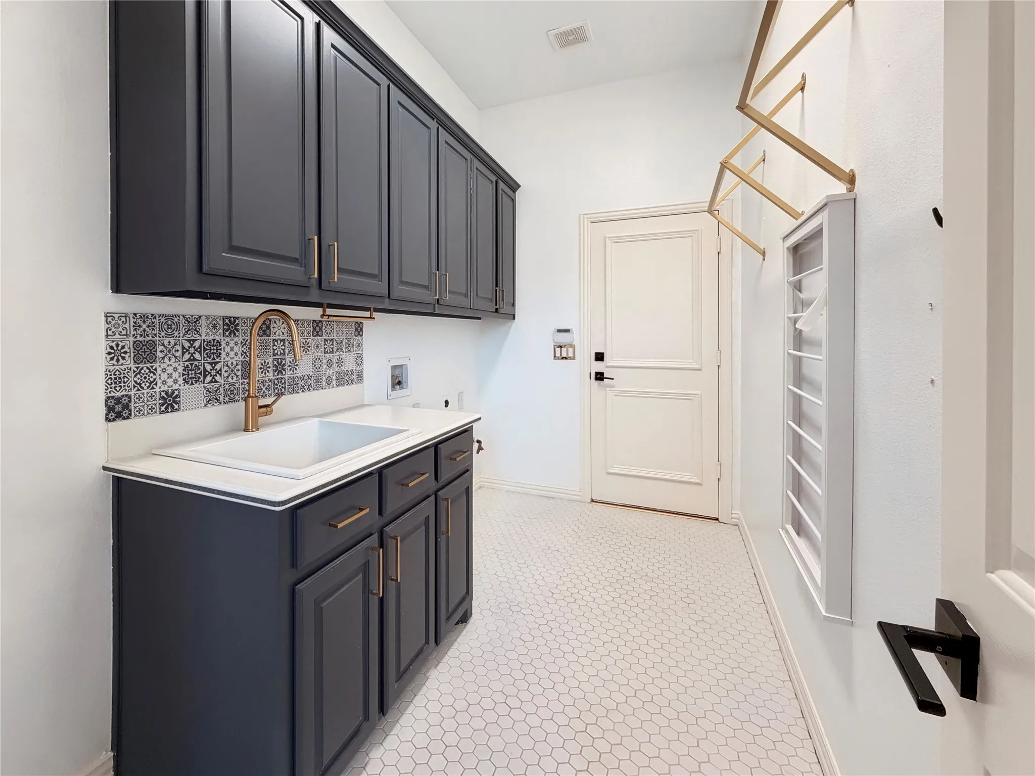 Laundry area featuring cabinet space, hookup for a washing machine, and light flooring