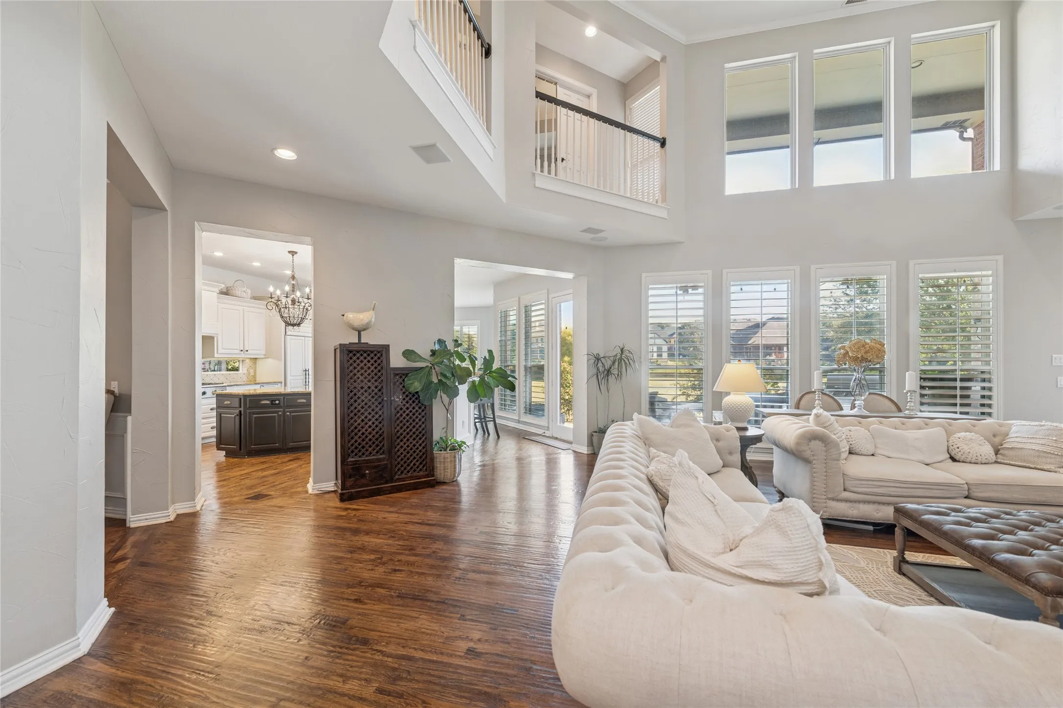 Living area with dark wood finished floors, recessed lighting, and a chandelier
